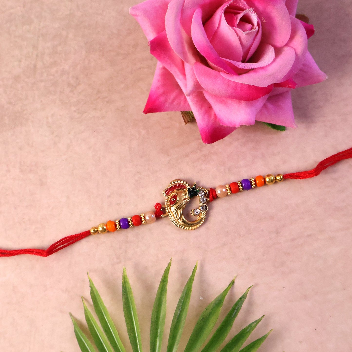 Elegant rakhi with detailed threadwork and embellishments