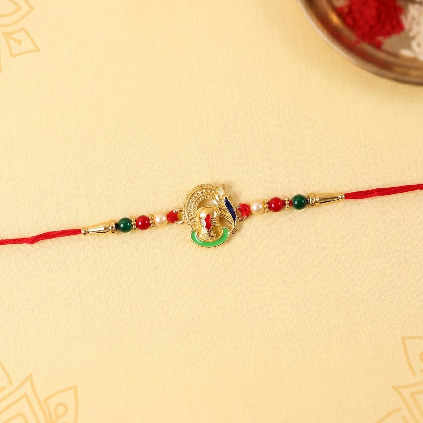 Top view highlighting thread and bead work on Ganesha Rakhi