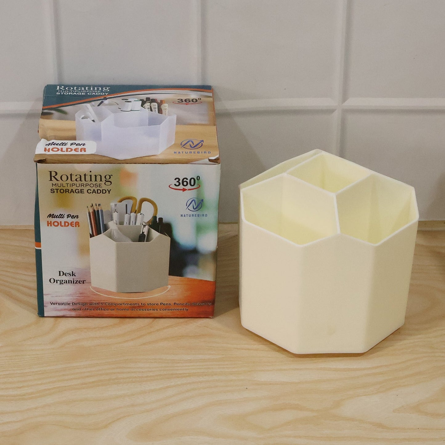 Close-up of compartments holding pens, scissors, and tapes in cream desk organizer