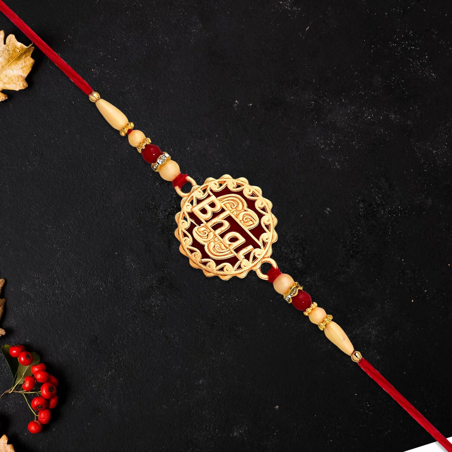 Elegant golden and red thread design for Bhai Rakhi