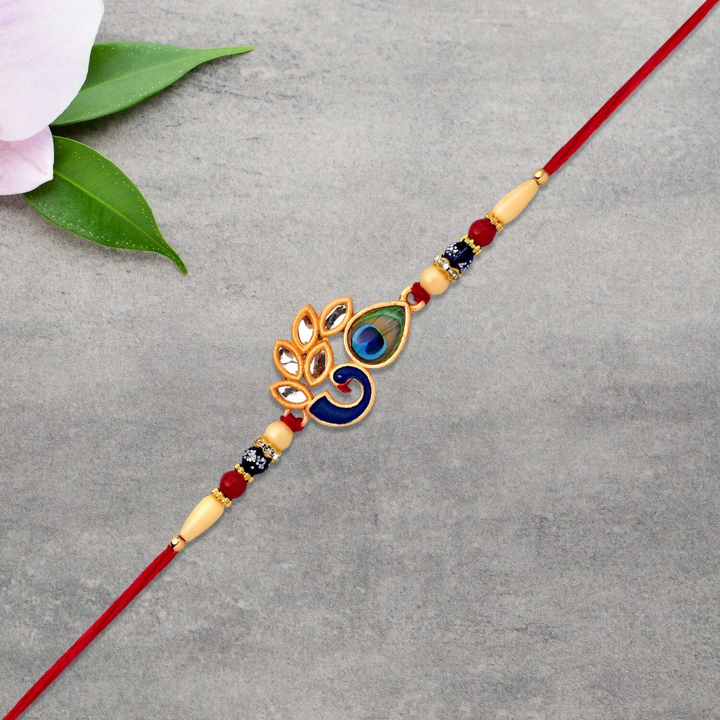 Handcrafted Mor Pankh Rakhi displaying traditional thread and enamel decoration