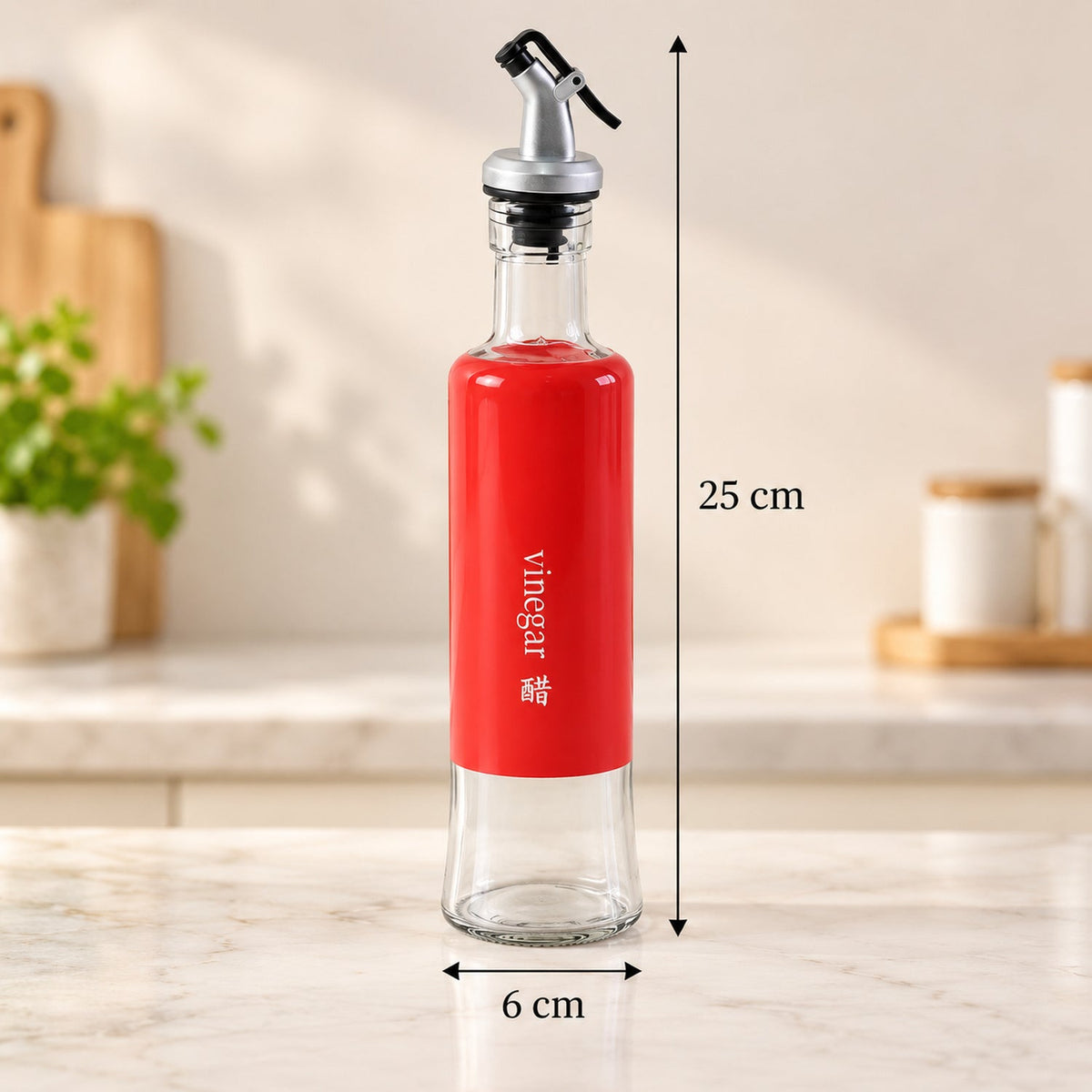 A clear glass bottle with a red label and pour spout stands on a kitchen counter, showing its height and width dimensions.