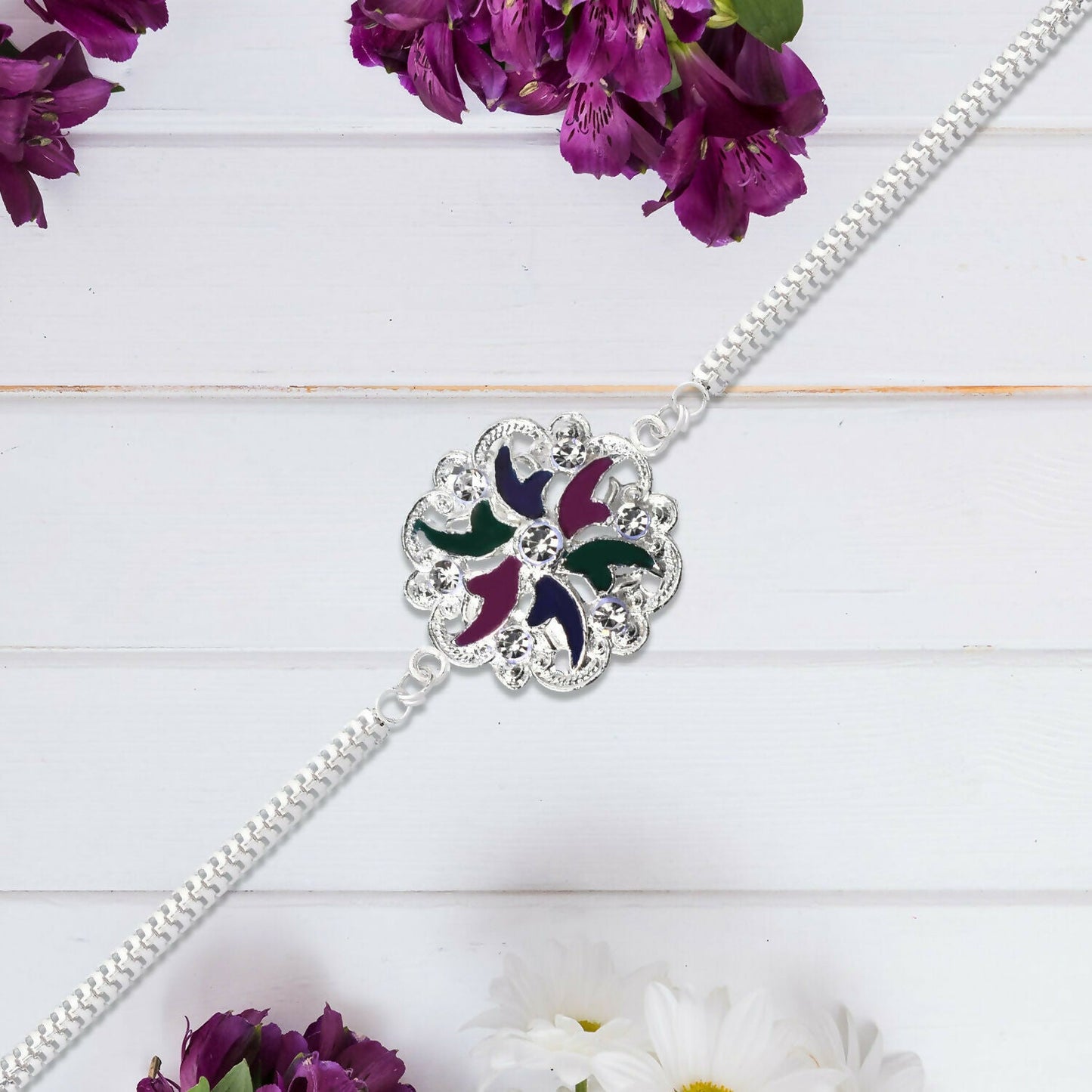 Close-up view of floral motif and detailed enamel work on Rakhi bracelet