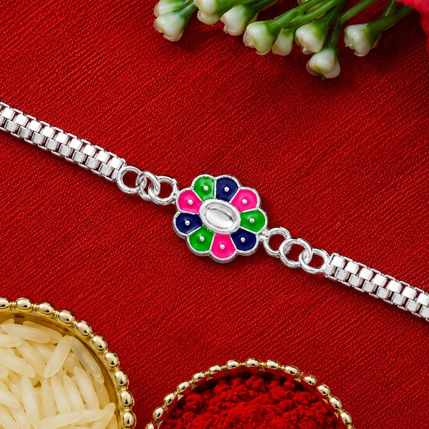 Back view of the enamel flower Rakhi, highlighting its smooth finish and sturdy construction.