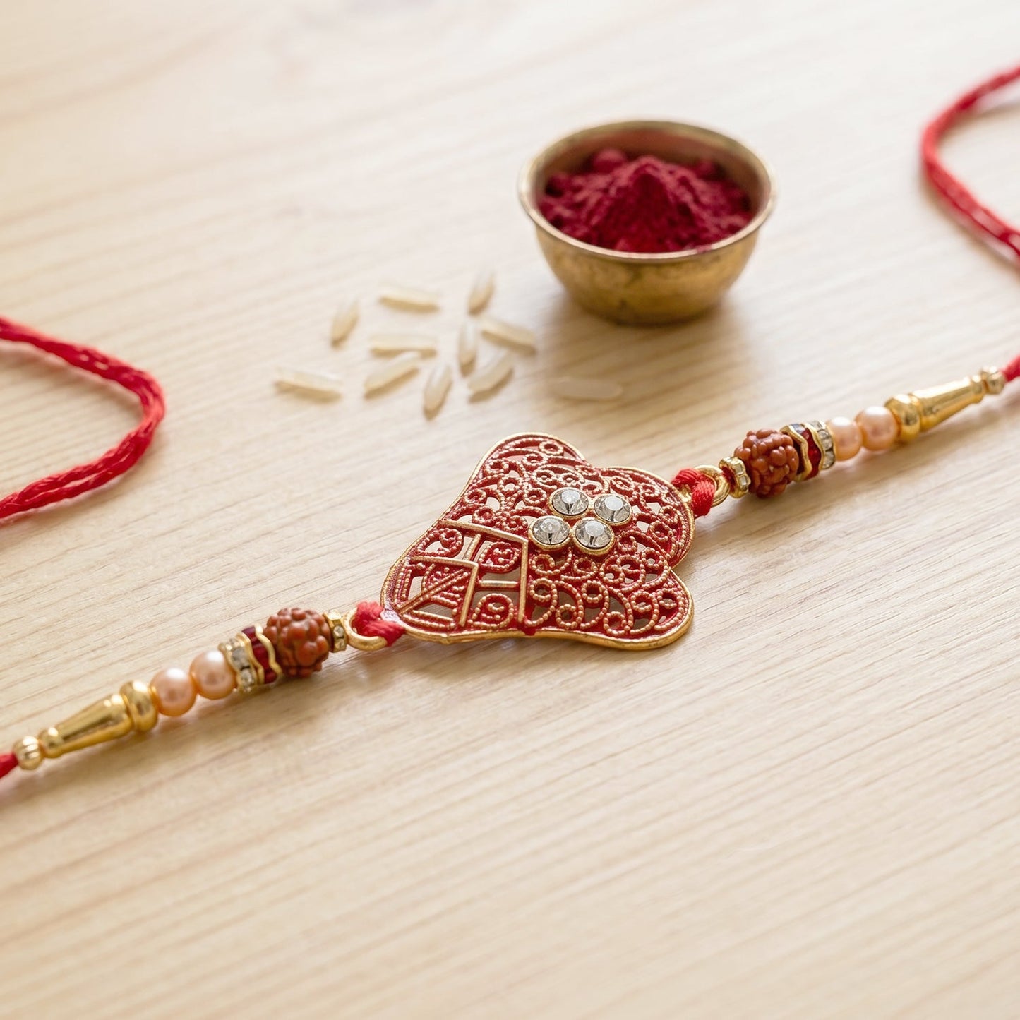 Side view of rakhi with gold beads and thread