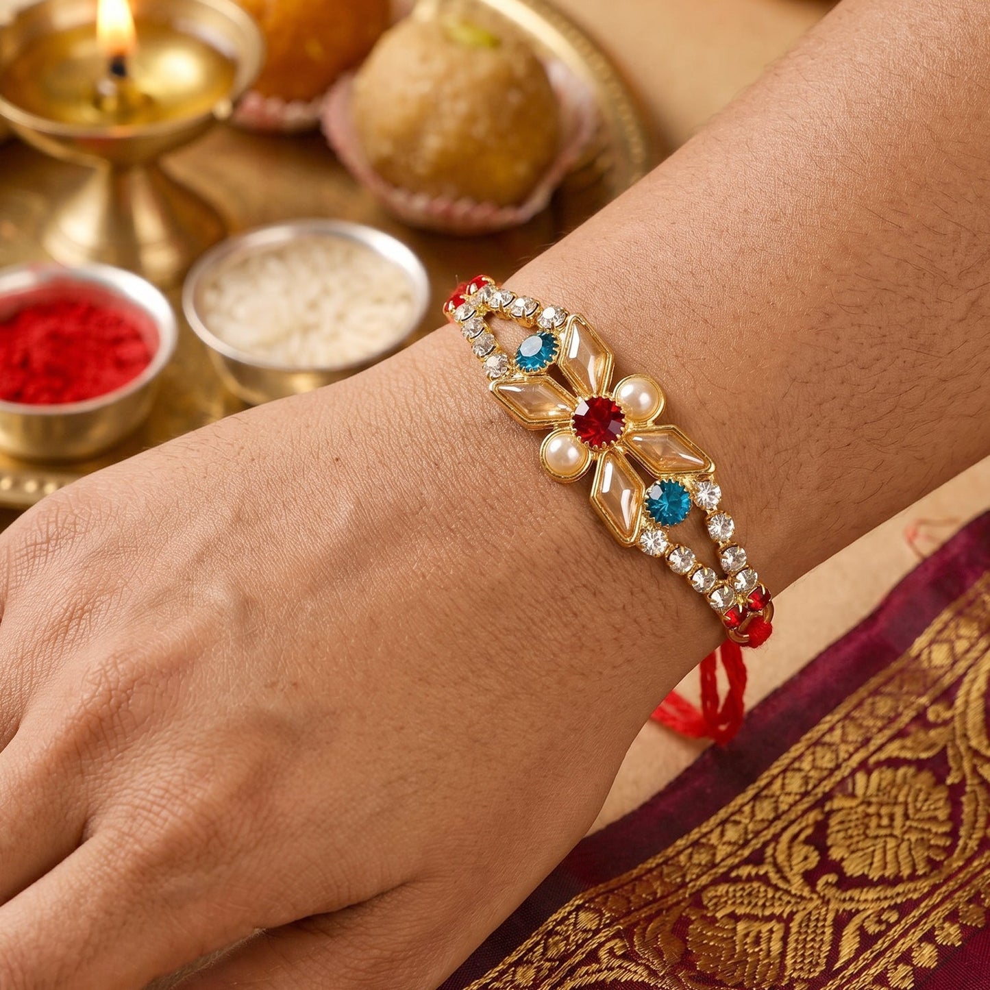 Side view of Pastel Floral Kundan Rakhi with decorative beads