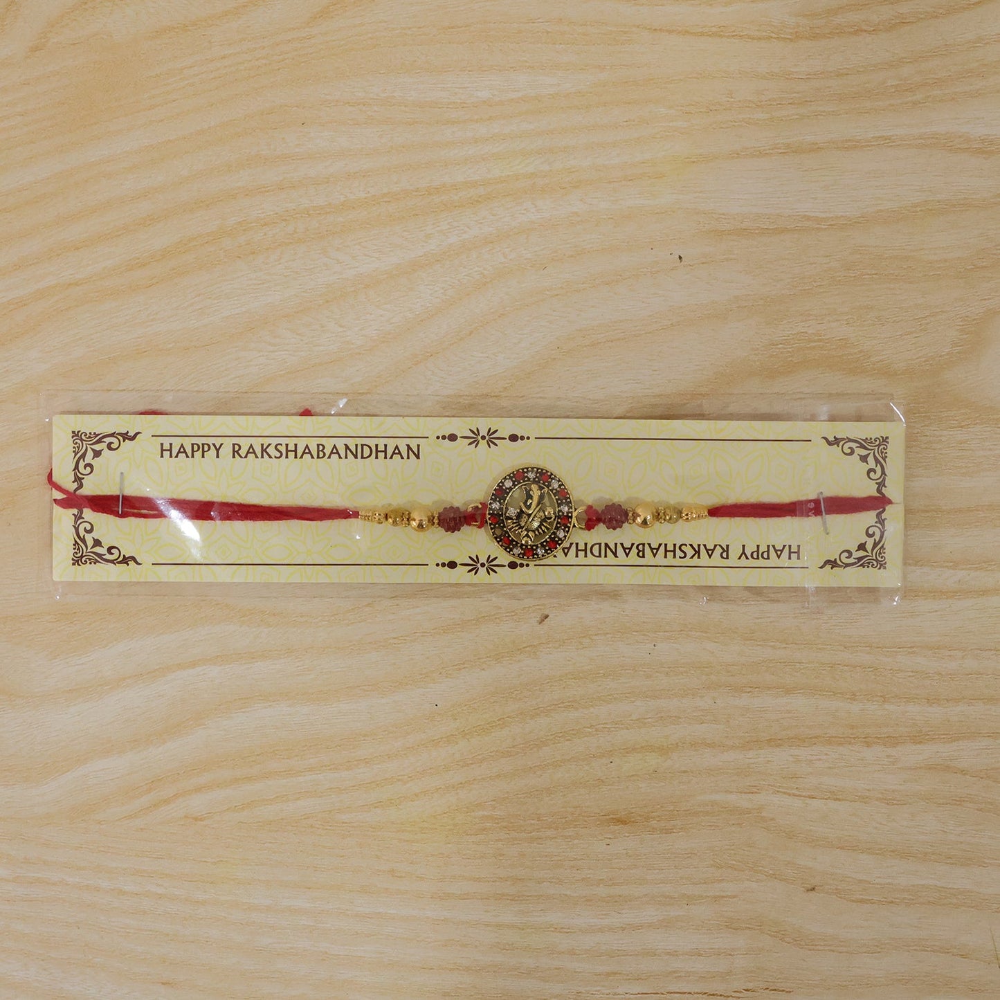 Full length Golden Ganesh Rakhi with red thread and beads