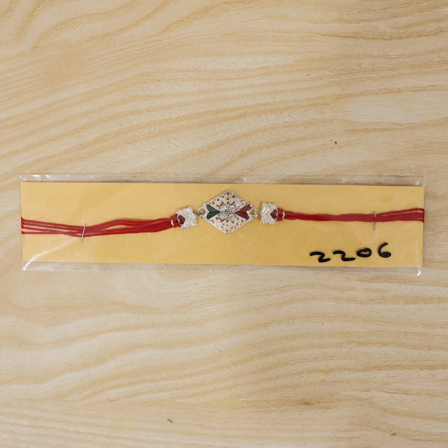 Silver elephant charm rakhi worn on wrist for Raksha Bandhan