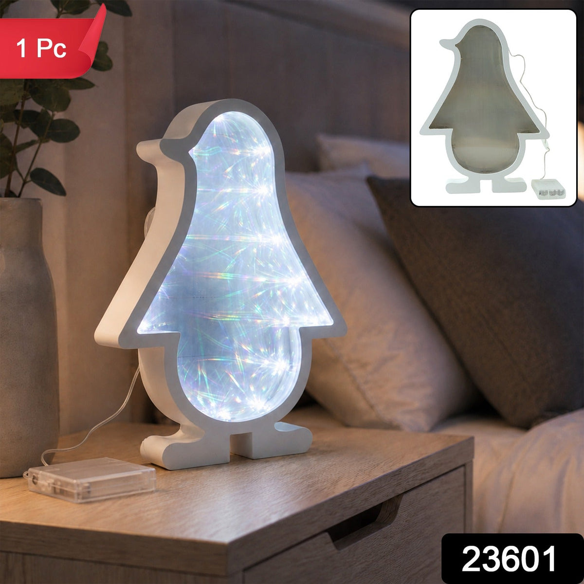 White penguin-shaped infinity mirror light with bright LED illumination, sitting on a wooden nightstand next to a – view 2