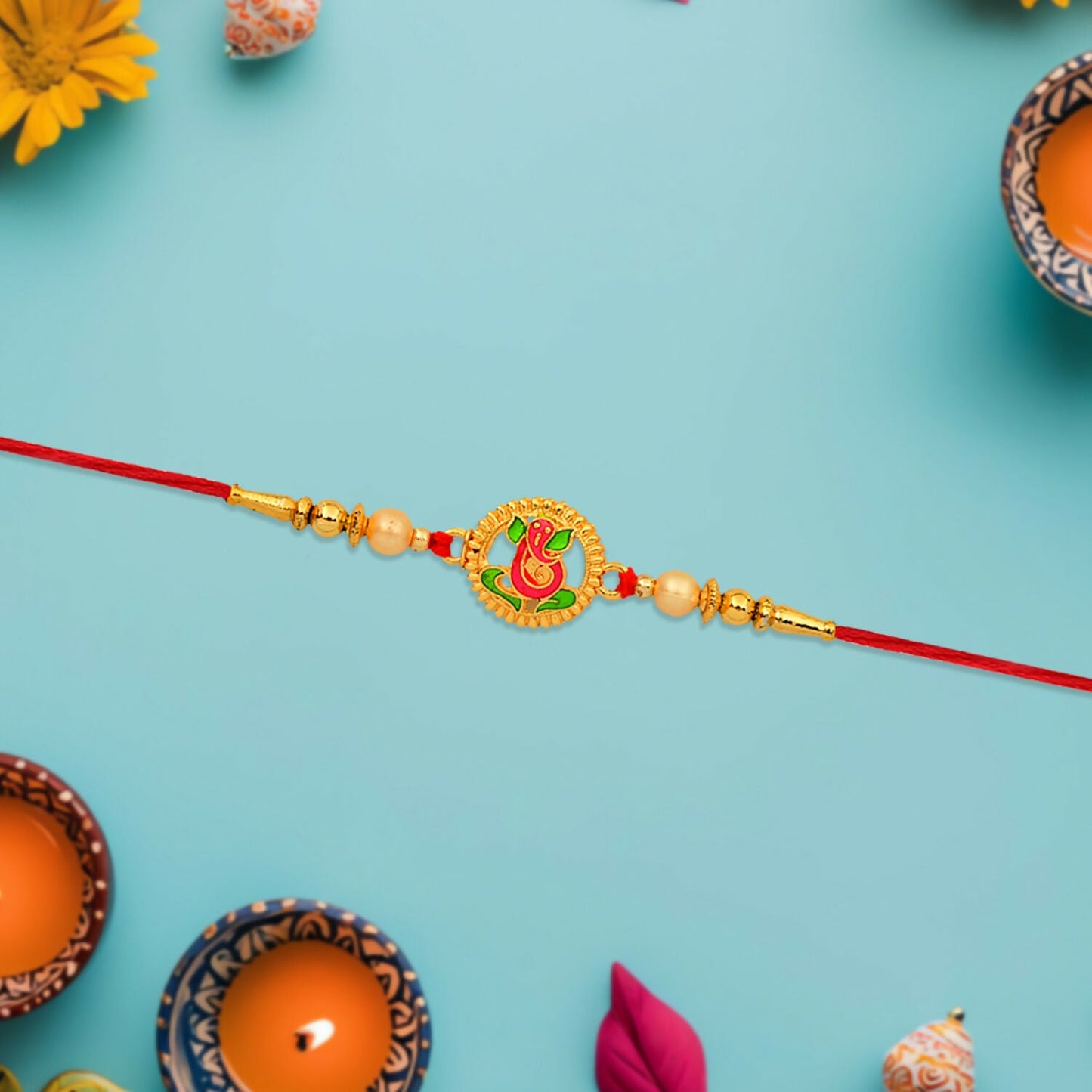Side view of traditional Ganesha Rakhi with enamel design and golden bead accents