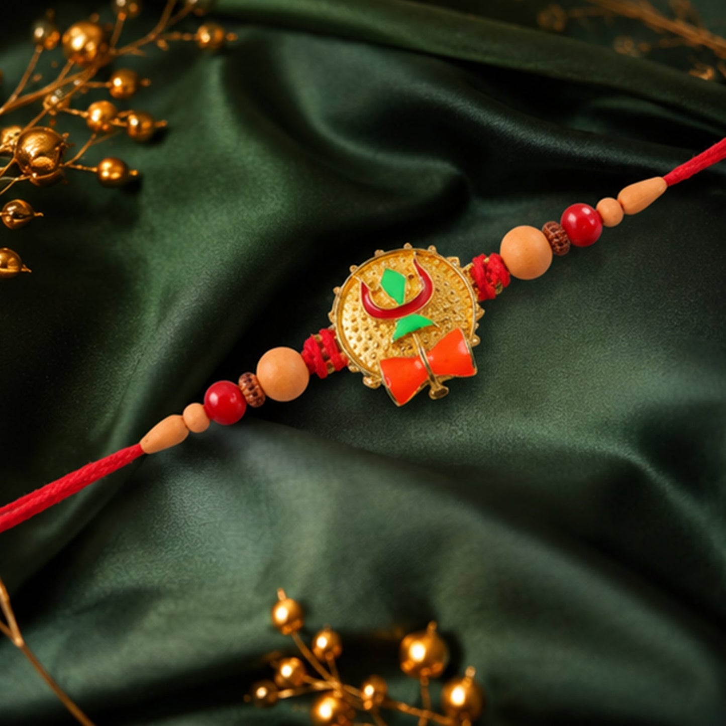 Side angle of Trishul Damru Rakhi showcasing decorative beads