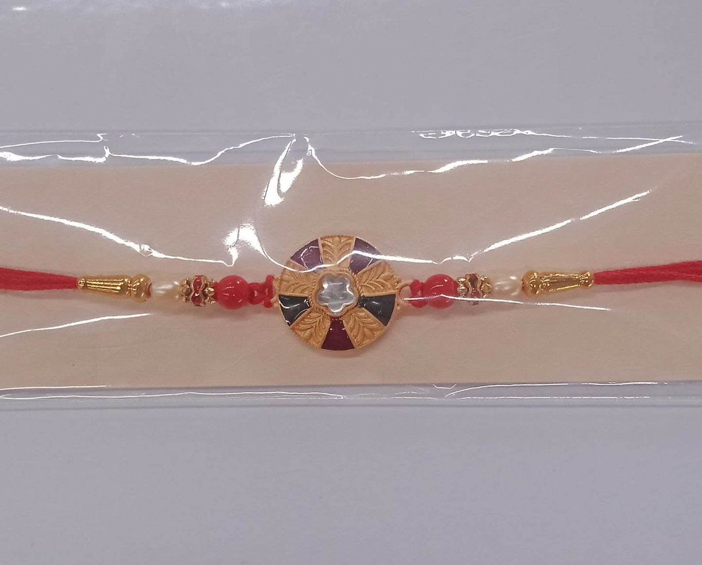 Handcrafted multicolor kundan rakhi with floral golden motif