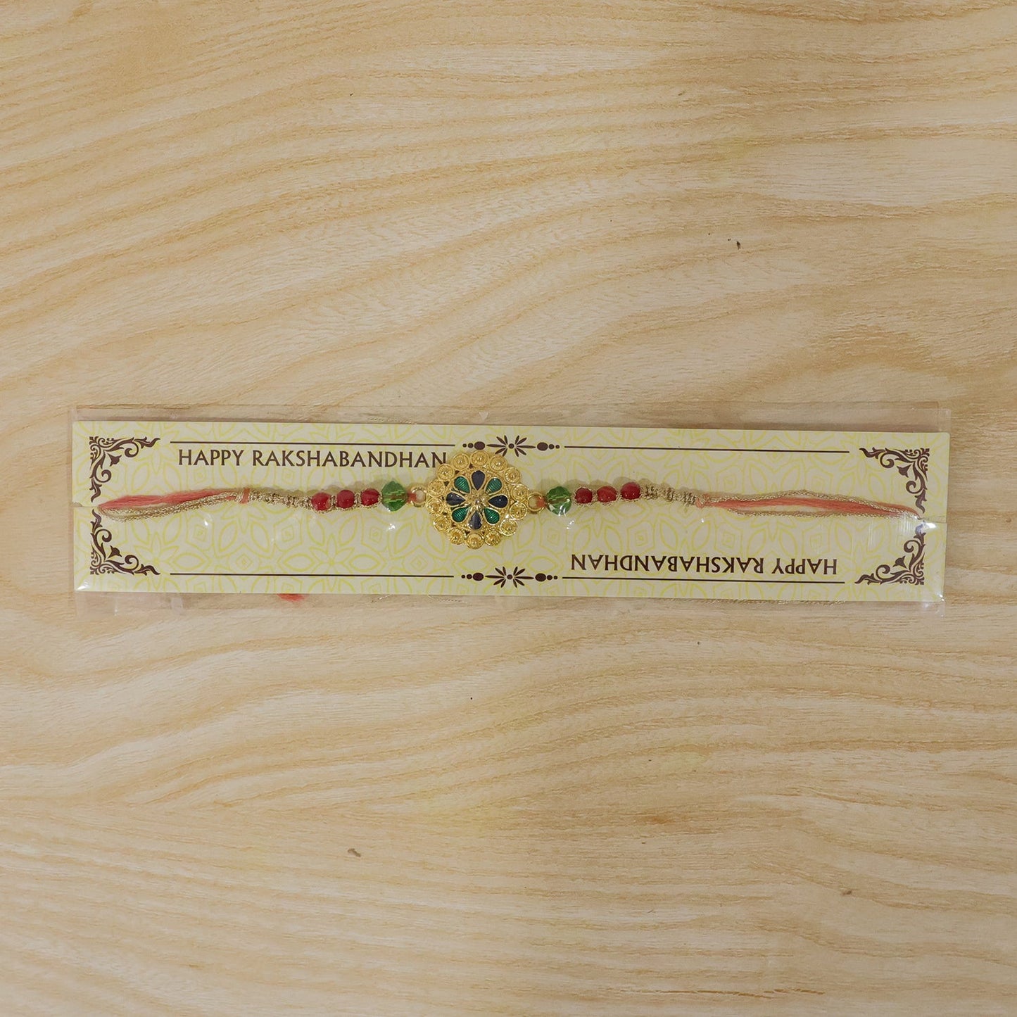 Decorative elements of Gold Blue Flower Rakhi displayed clearly