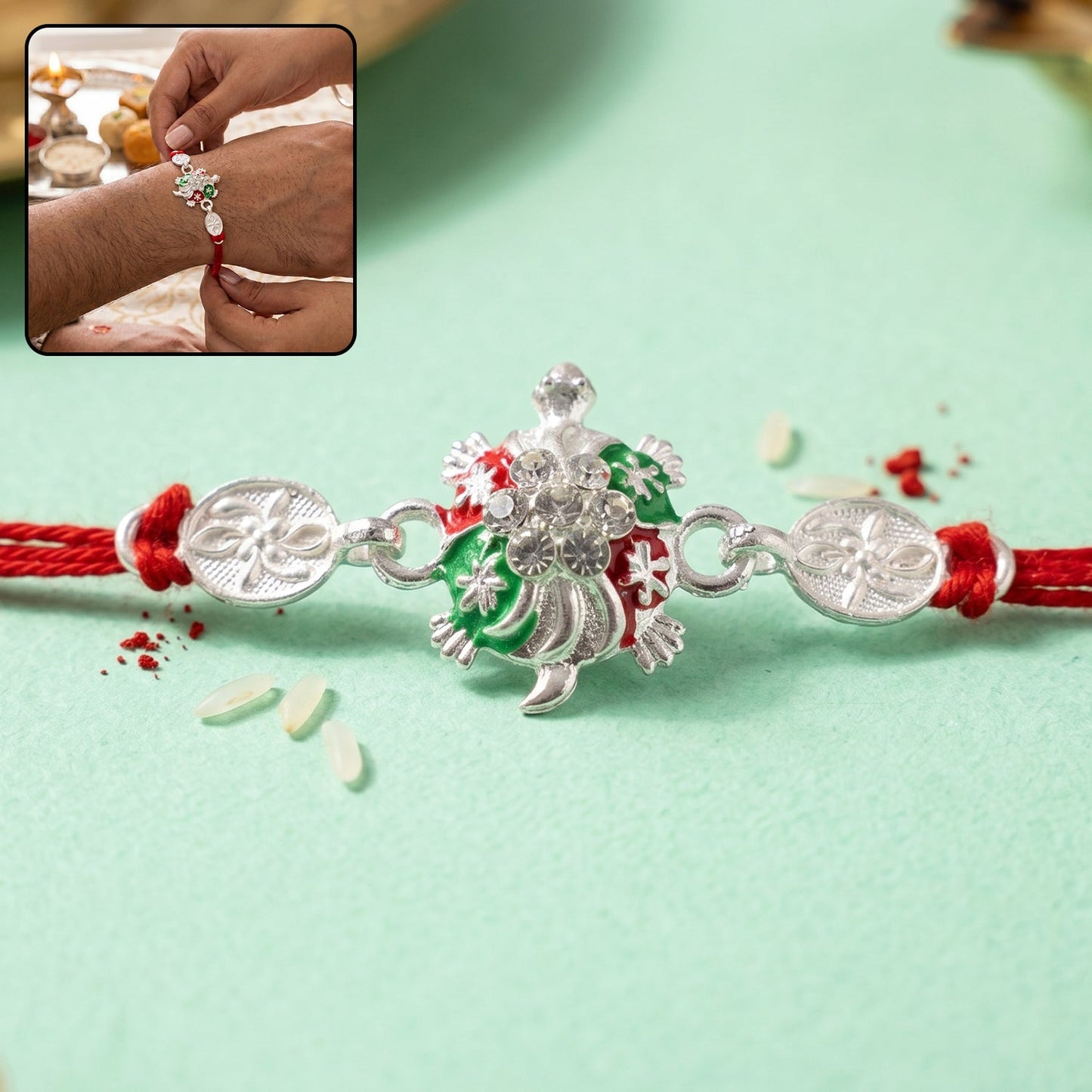 Turtle Rakhi with shimmering crystals, green enamel center, and red thread, viewed from the front.