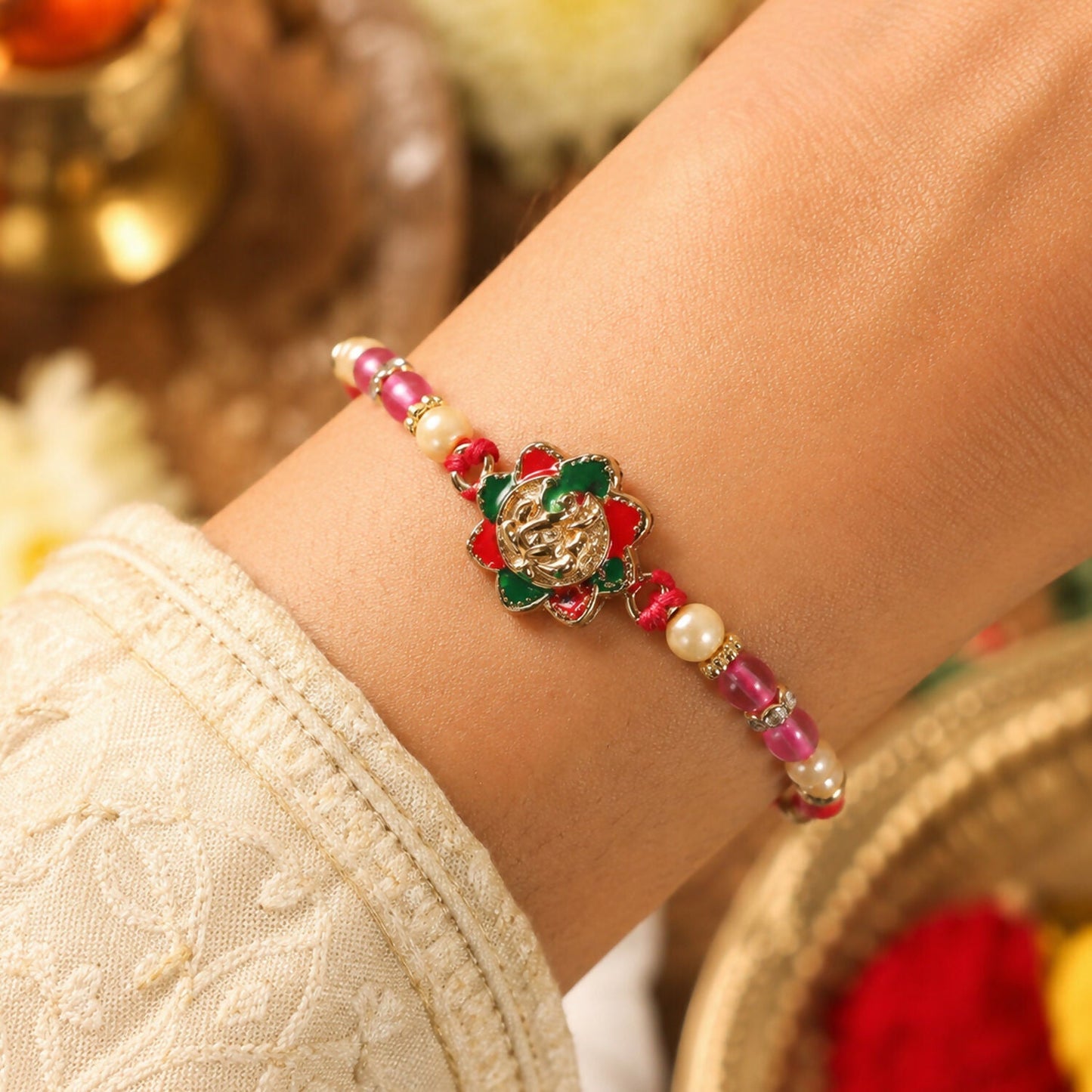 Colorful floral beads Ganesha Rakhi for brother and sister