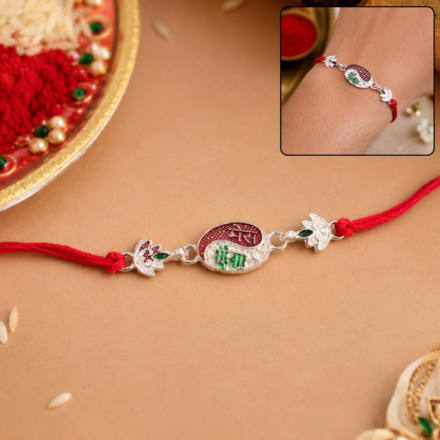 Close-up of a decorative Designer Rakhi with an oval charm and red thread.