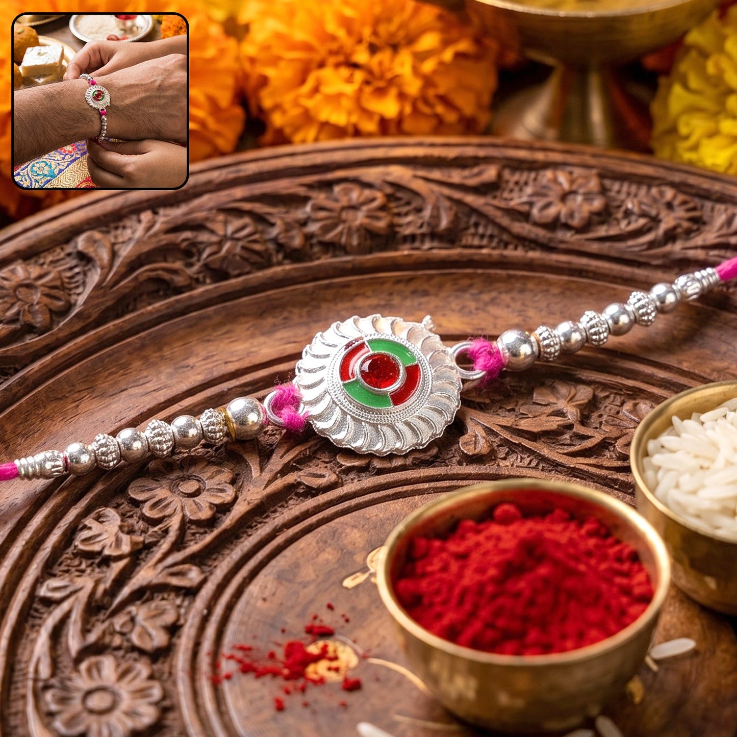 Silver round floral rakhi with red stone and pink beads on white background