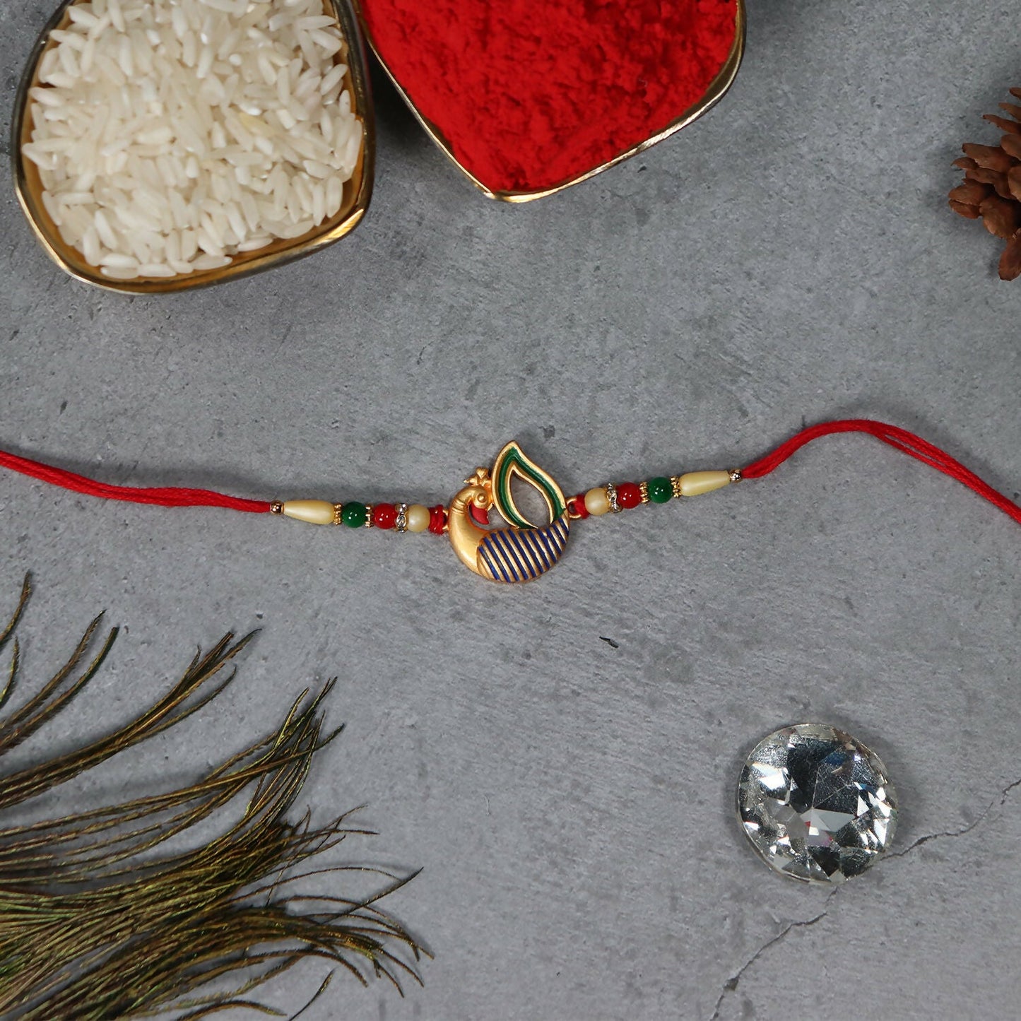 Peacock Feather Rakhi tied delicately on brother's wrist, showcasing elegant handcrafted thread.