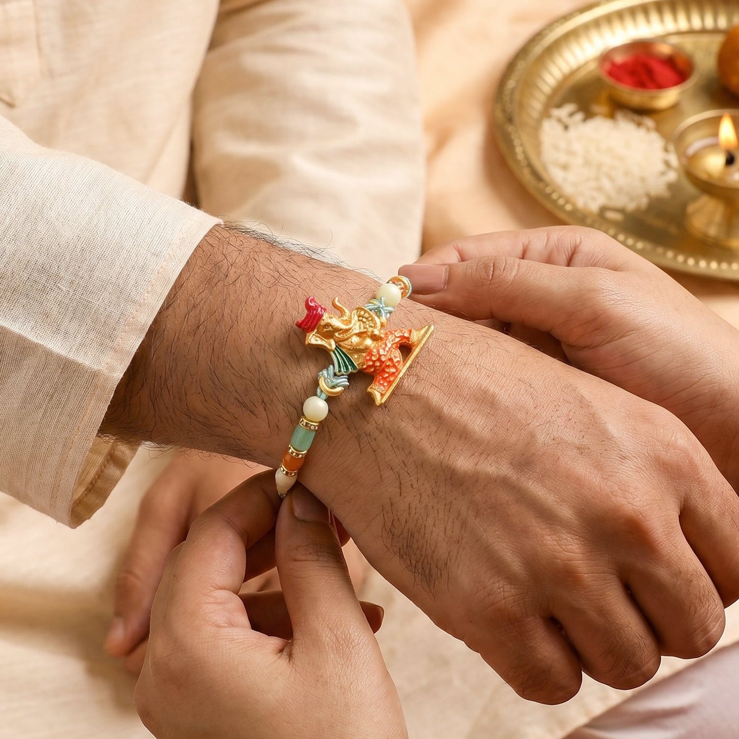 Top view of Ganesh rakhi showing beads and thread detail