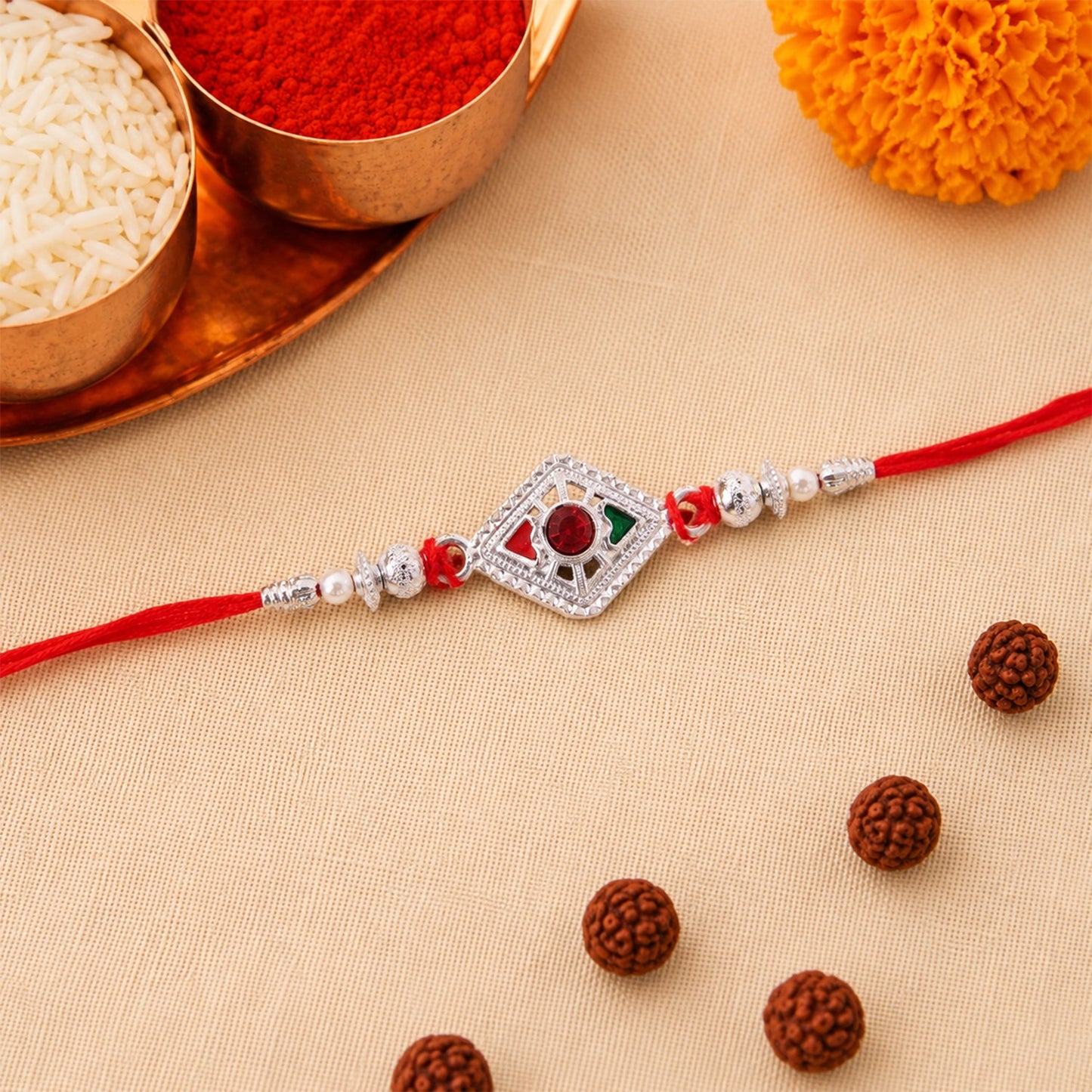 Detailed view of decorative beads on silver rakhi