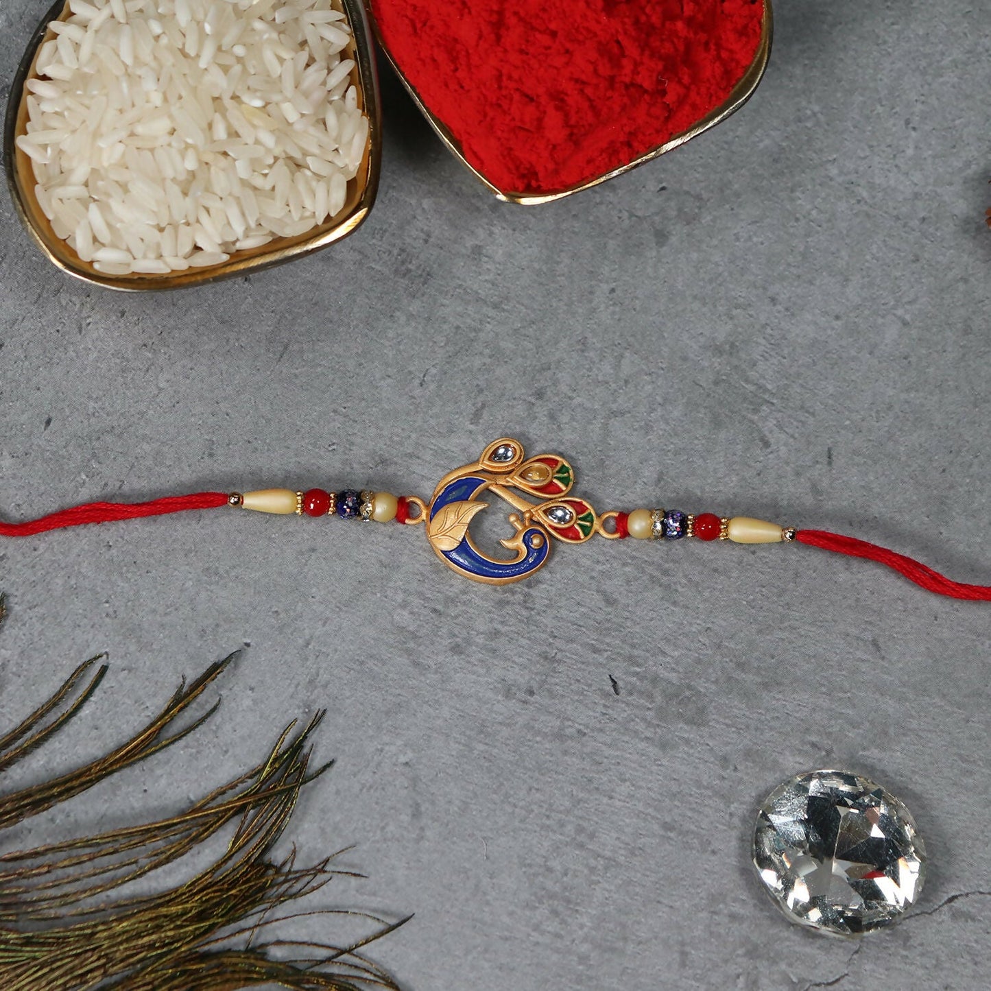 Close-up of the colorful peacock design on the exquisite Meenakari Rakhi.