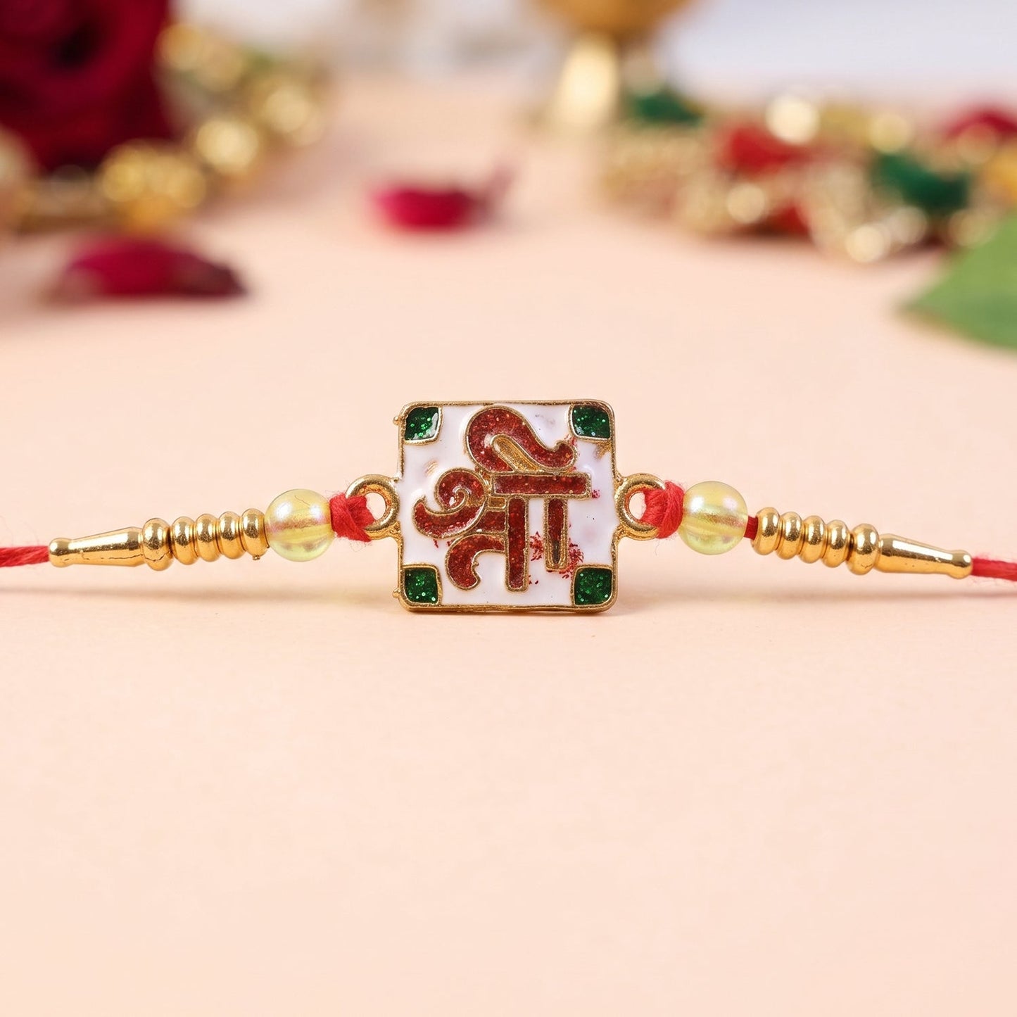 Green stones detail on the Shree Symbol Rakhi