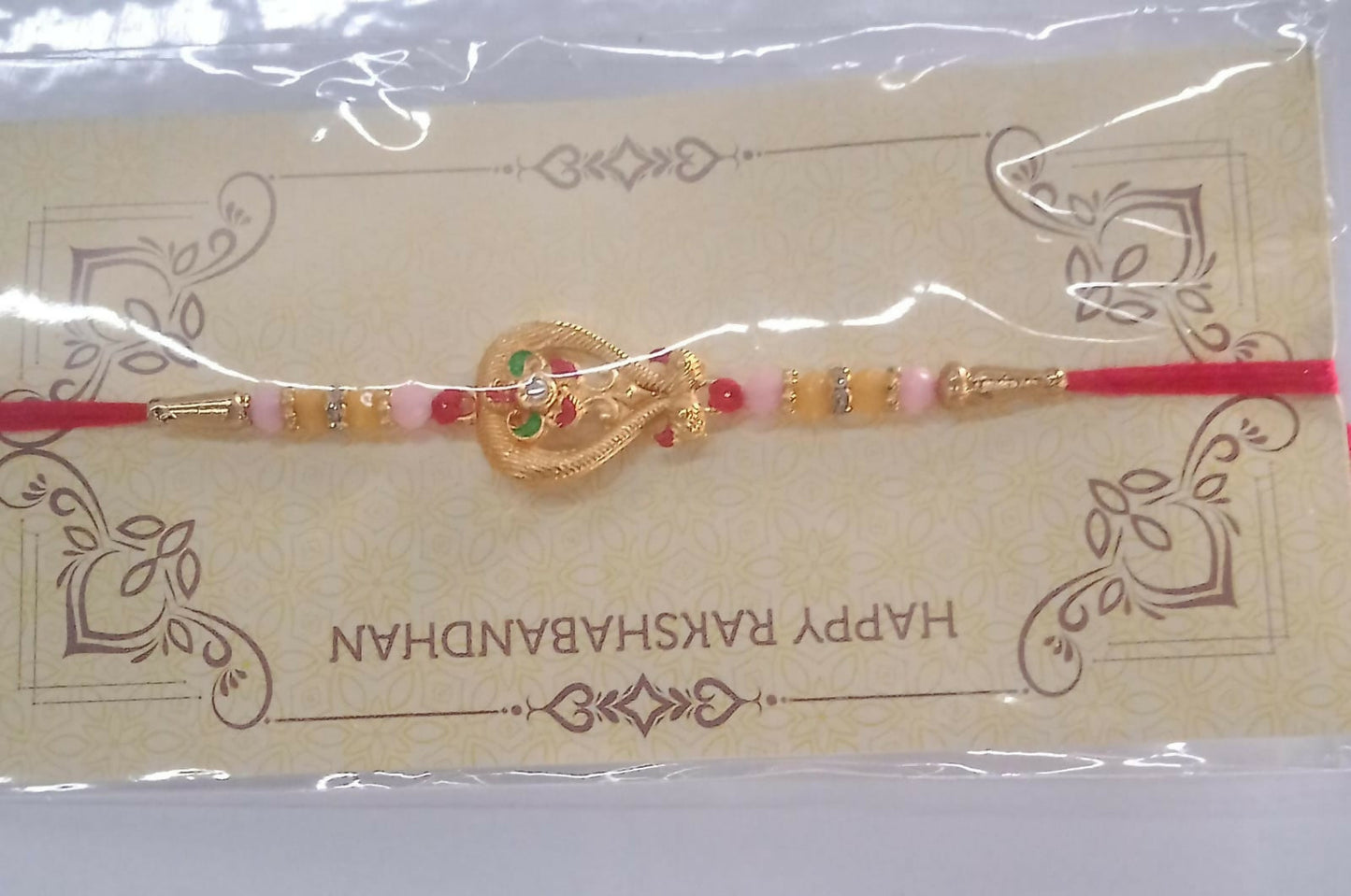 Beautifully displayed designer Rakhi for brother on rustic wooden surface.