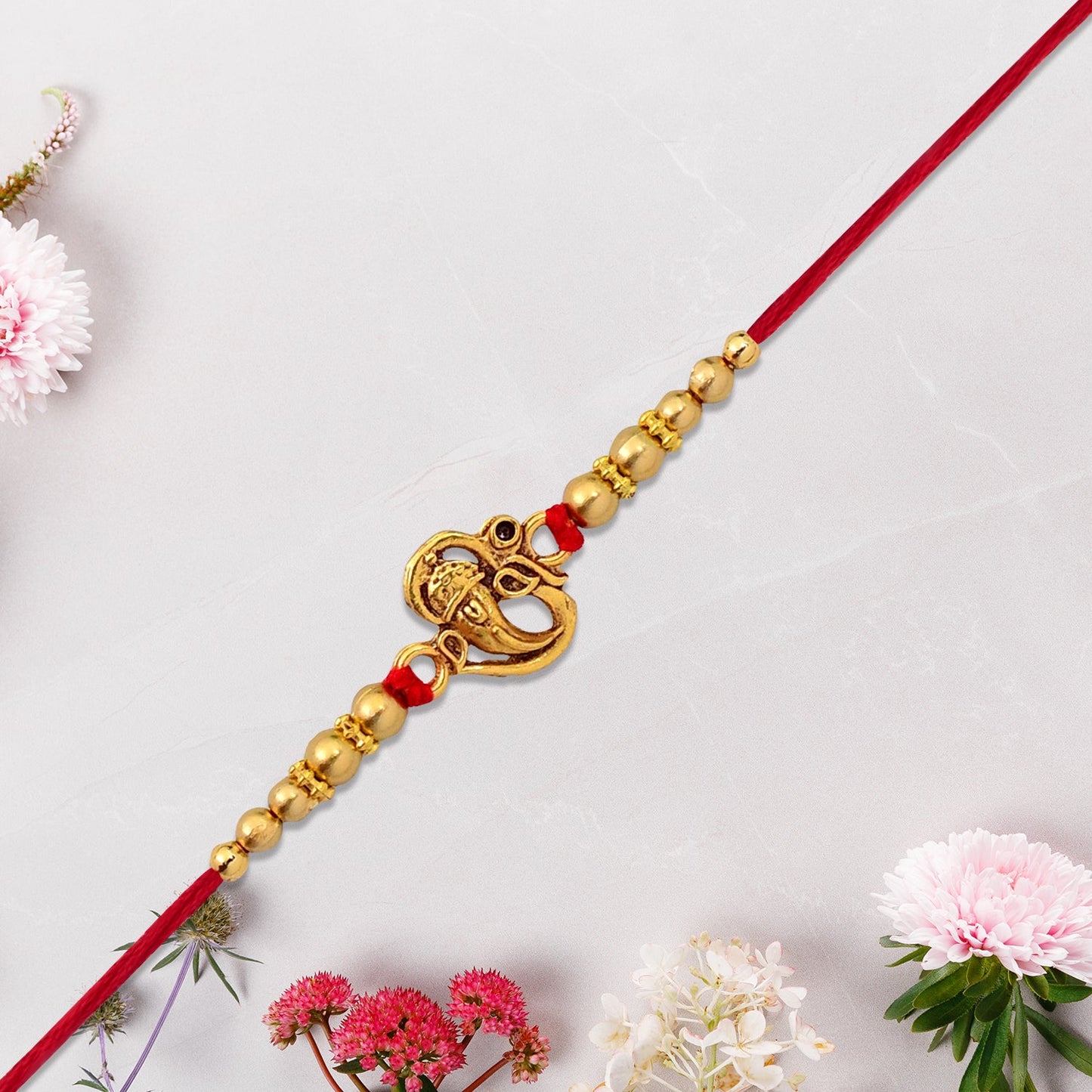Brother's hand adorned with a sacred Ganesha Rakhi, symbolizing love.