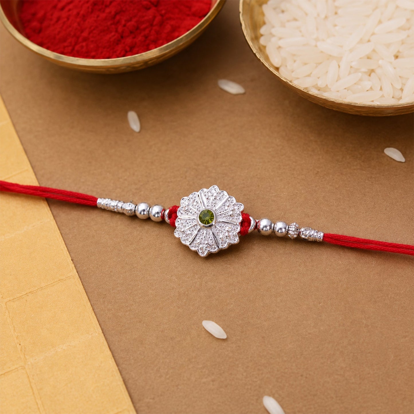 Elegant Rakhi with beaded accents and green stone in focus