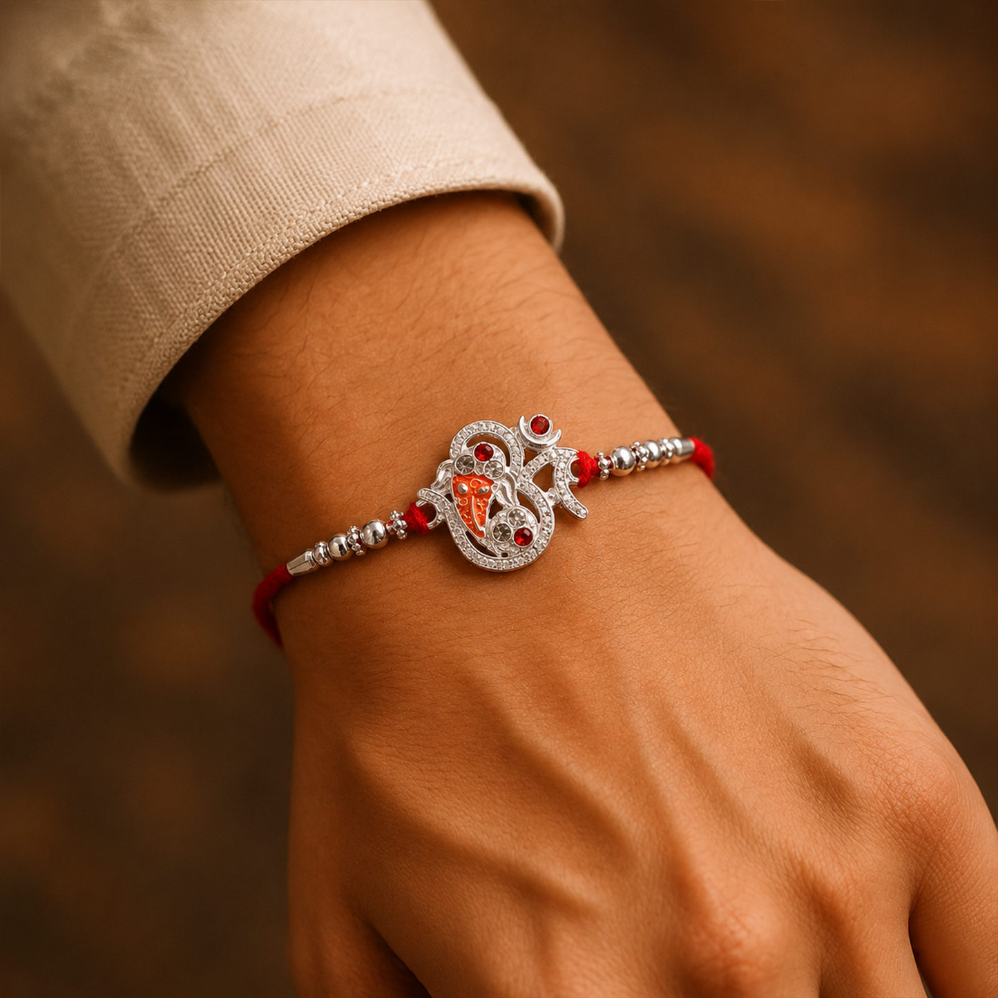 Close-up view of Silver Ganesh design on rakhi bracelet symbolizing blessings