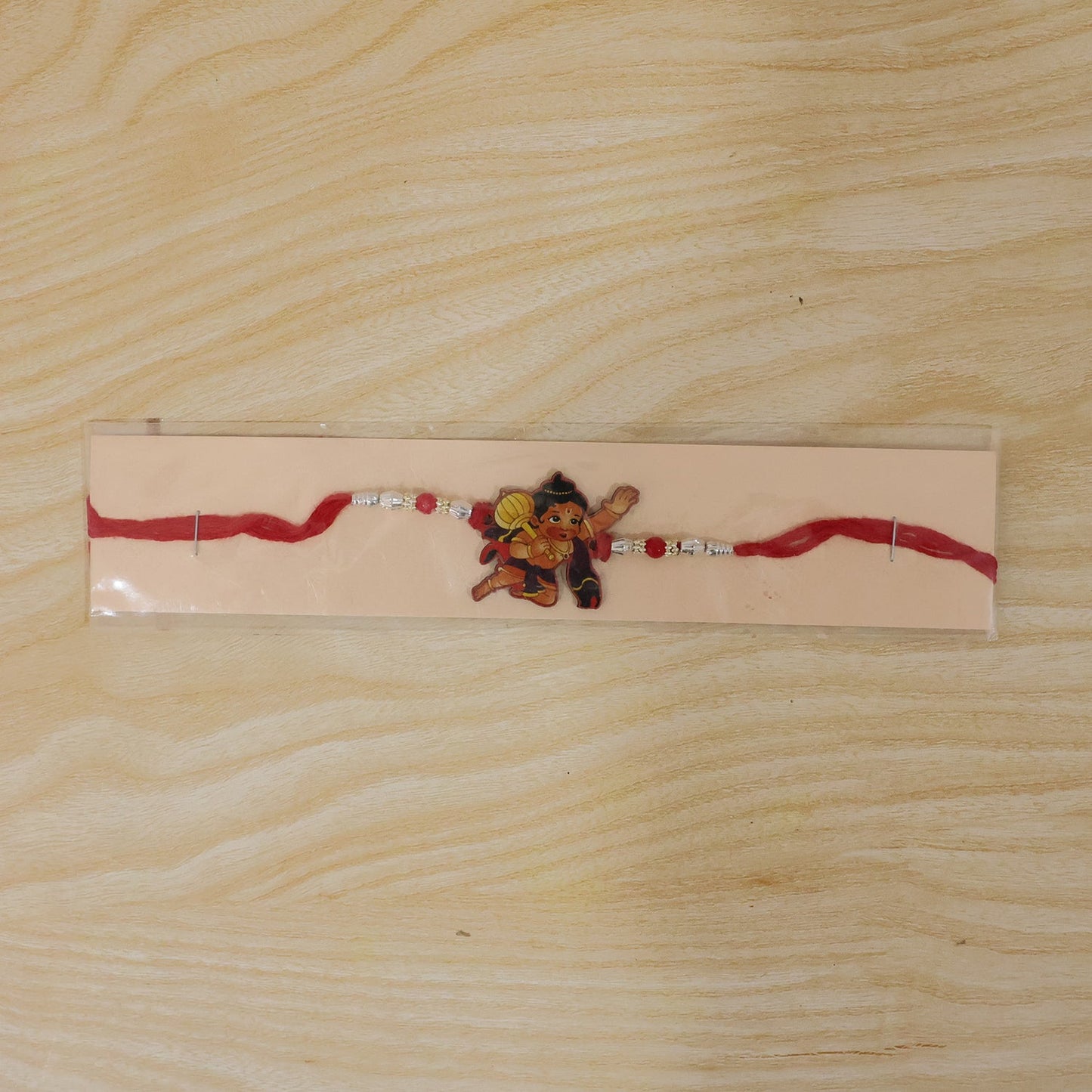 Full view of Bal Hanuman cartoon Rakhi with silver chain