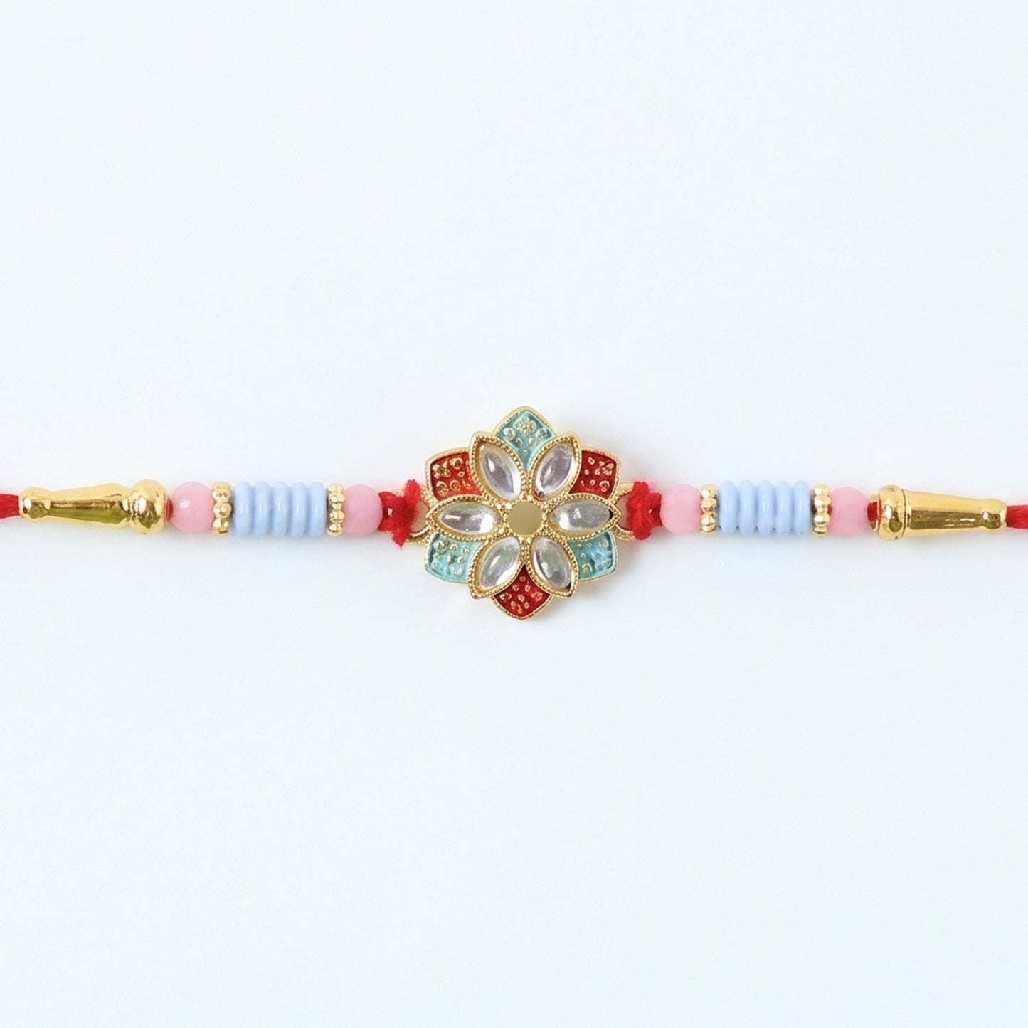 Side view of floral kundan star petal Rakhi with soft thread