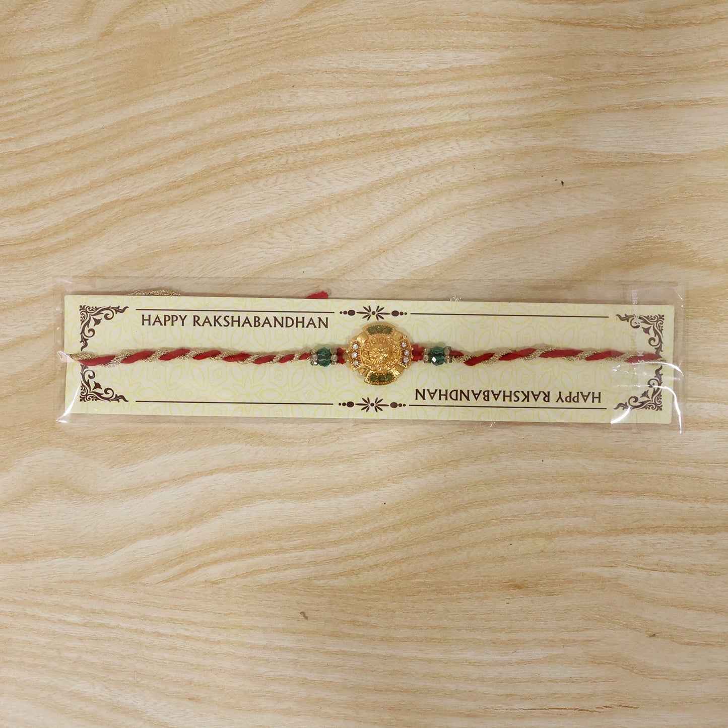 Top-down view of the gold floral Rakhi for Raksha Bandhan.