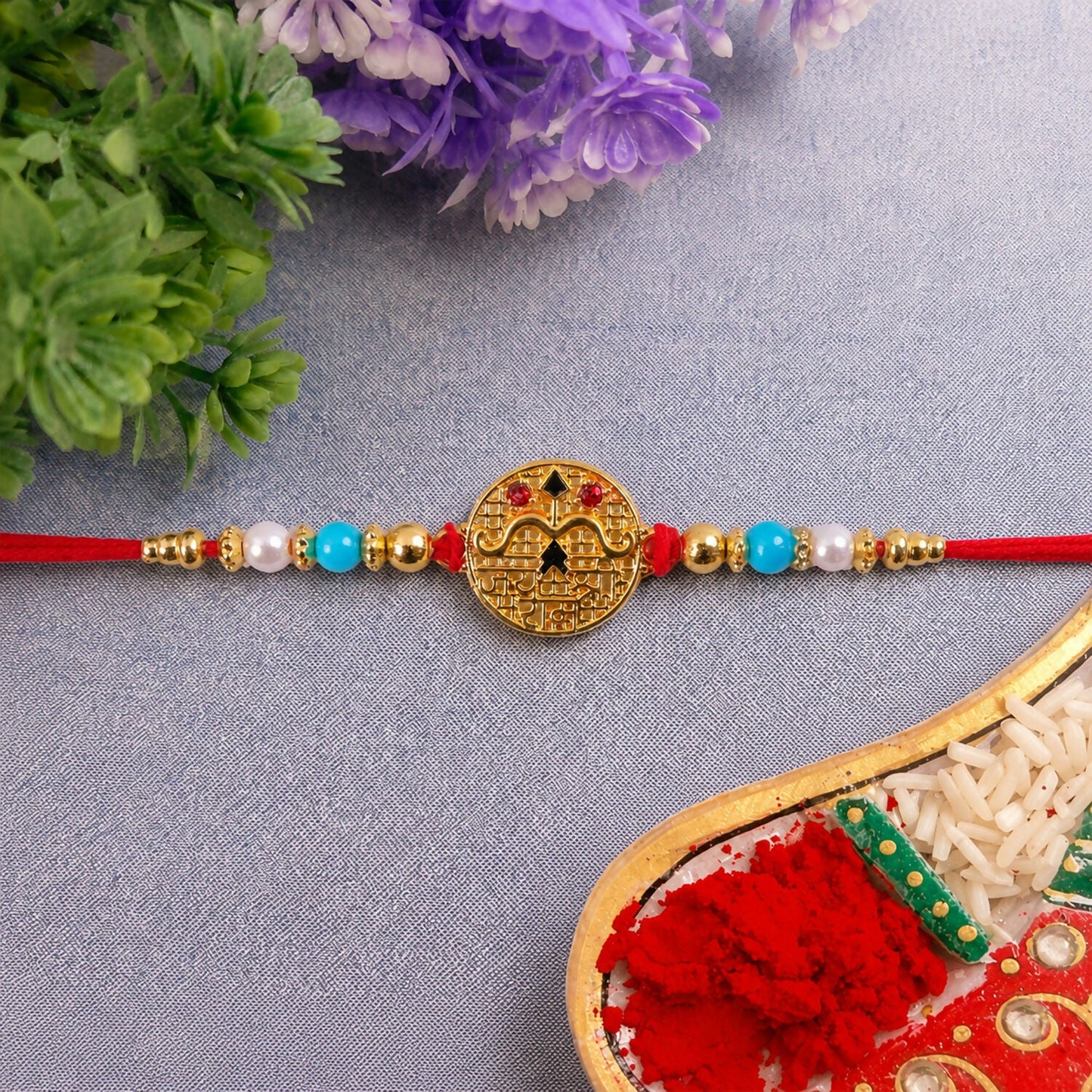 Side view of Golden Shri Ram Rakhi showing blue beads