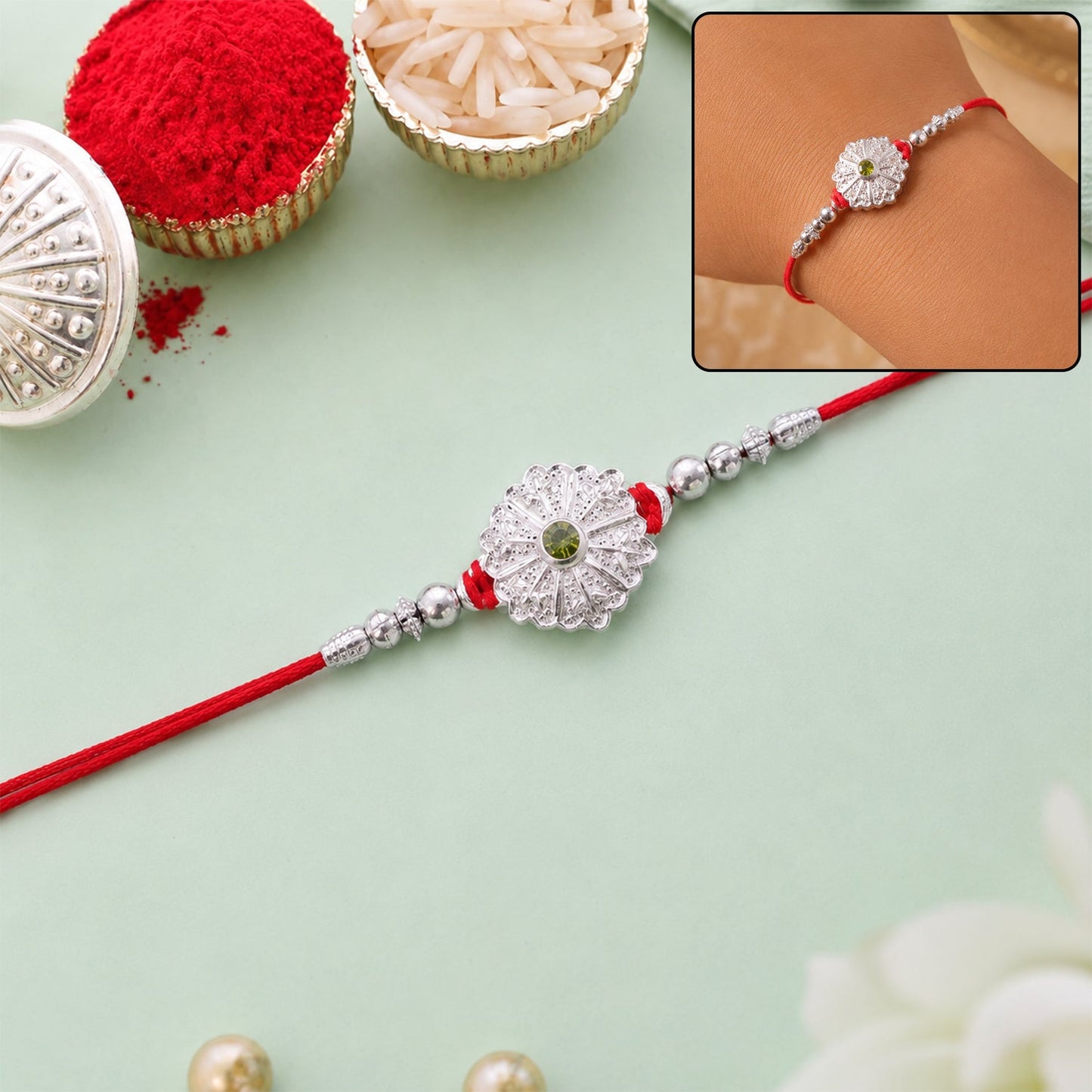 Close-up of a festive Rakhi with green stone and beaded details for Raksha Bandhan