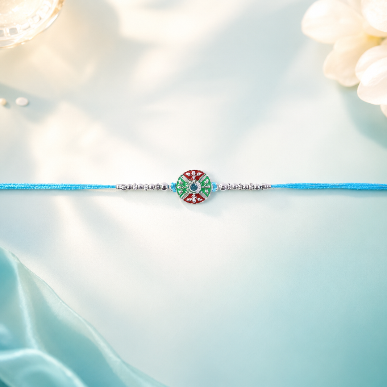 Elegant traditional rakhi with detailed finish and colorful centerpiece