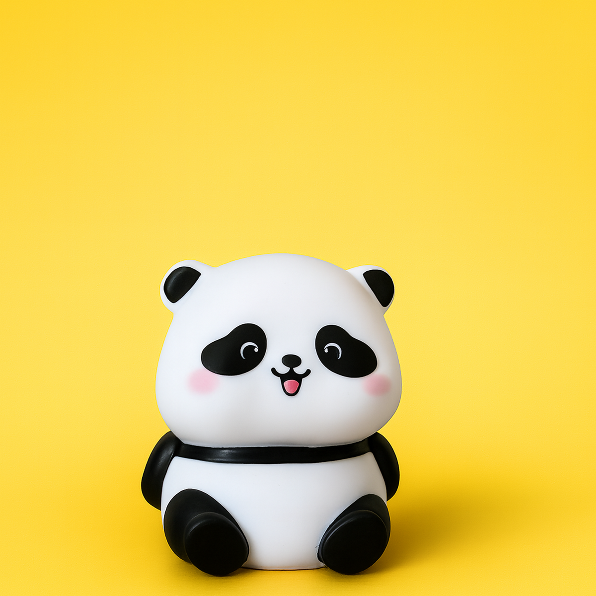 Panda LED night lamp emitting soft warm light on a surface