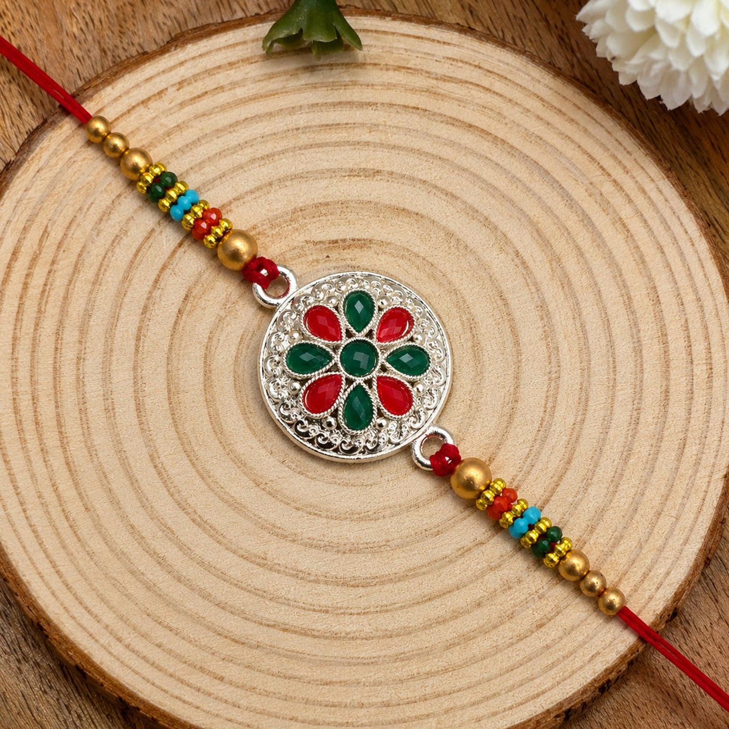 Silver Plated Floral Rakhi with Red and Green Stones
