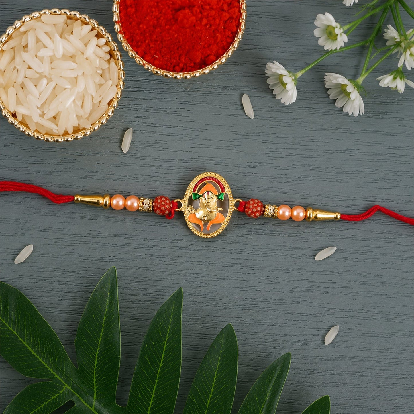 Close-up of Ganesha centerpiece on rakhi with decorative beads