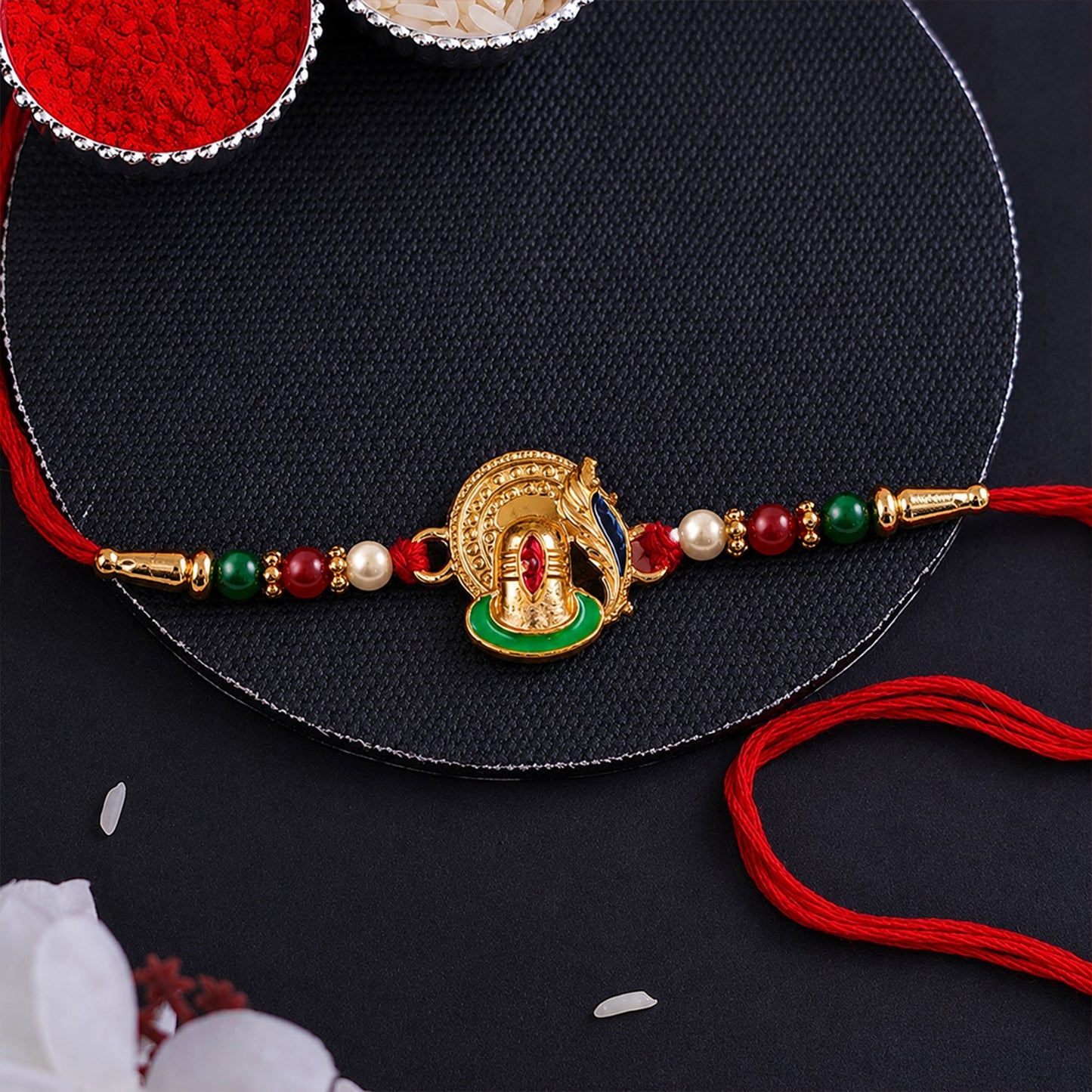 Traditional Ganesha Rakhi with decorative beads and soft thread