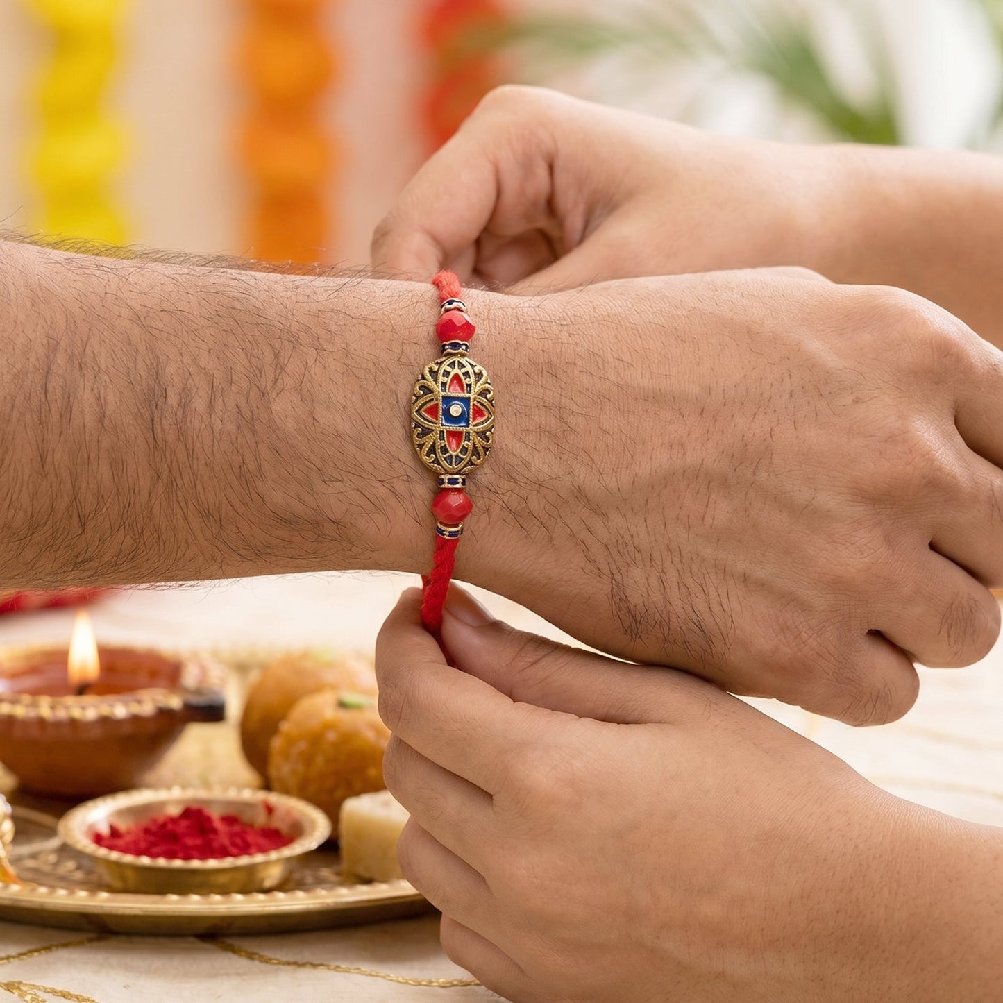 Top view of vibrant meenakari Bhabhi Rakhi with pearl embellishments