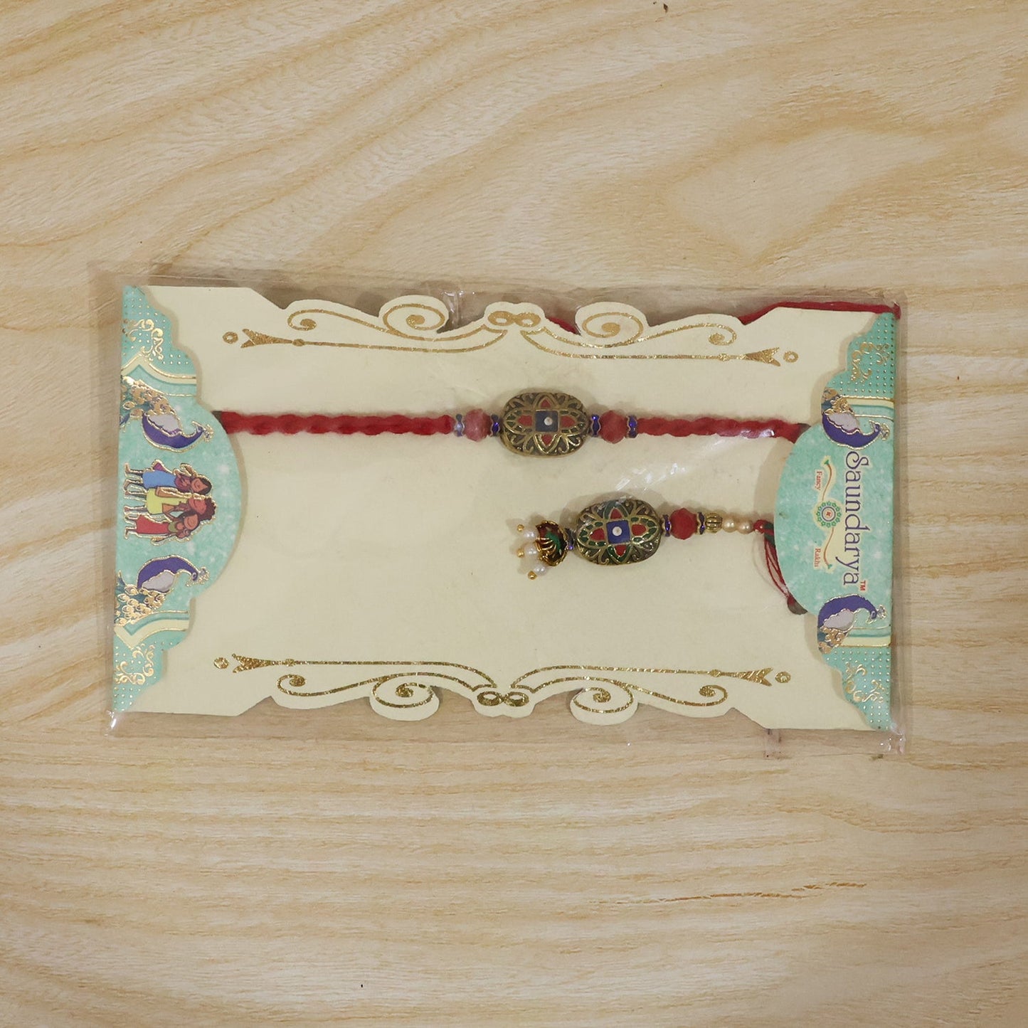 Decorative pearl latkan detail on colorful meenakari Rakhi