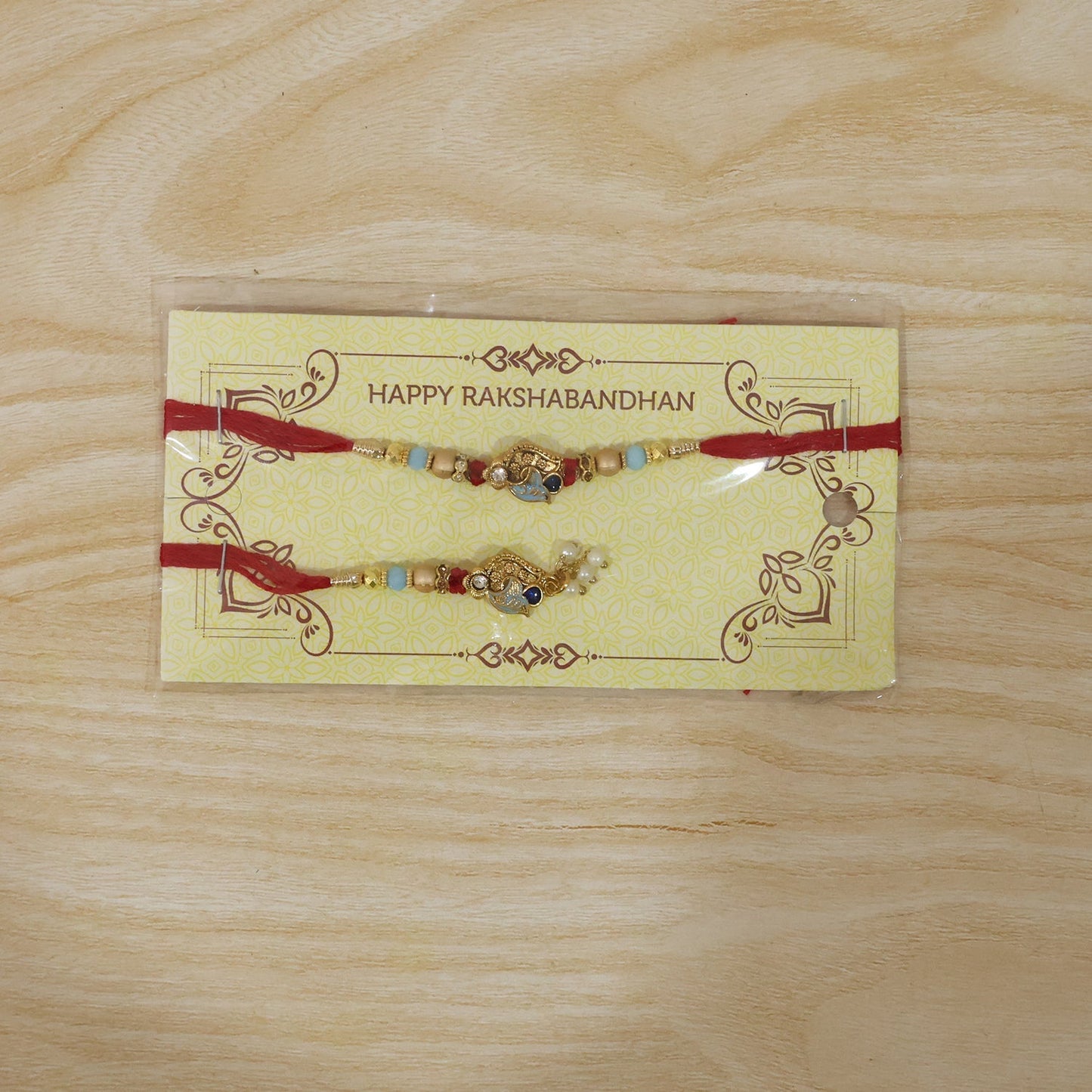 Close-up of Pearl Bead Bhabhi Rakhi with colorful Latkan