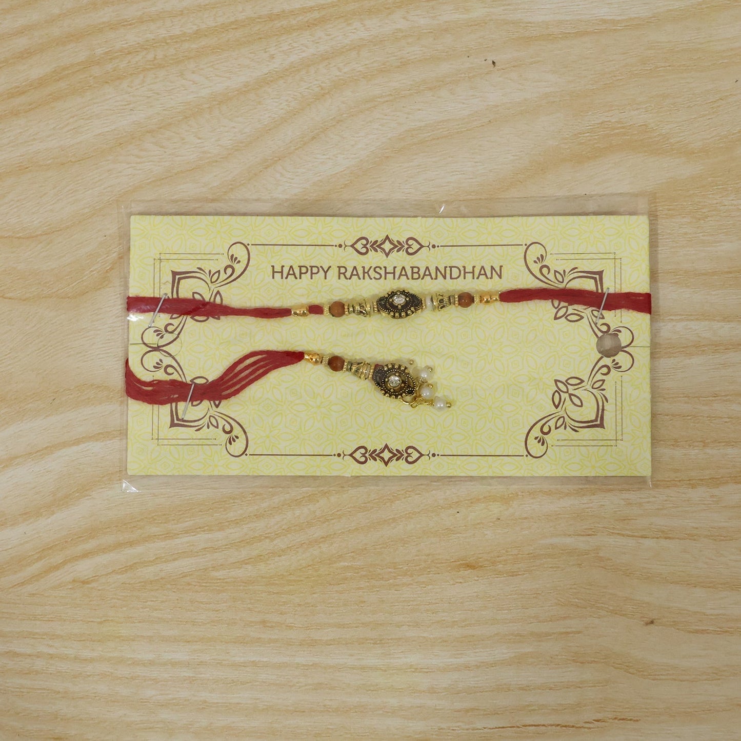 Antique stone Bhabhi Rakhi displayed with pearl beads