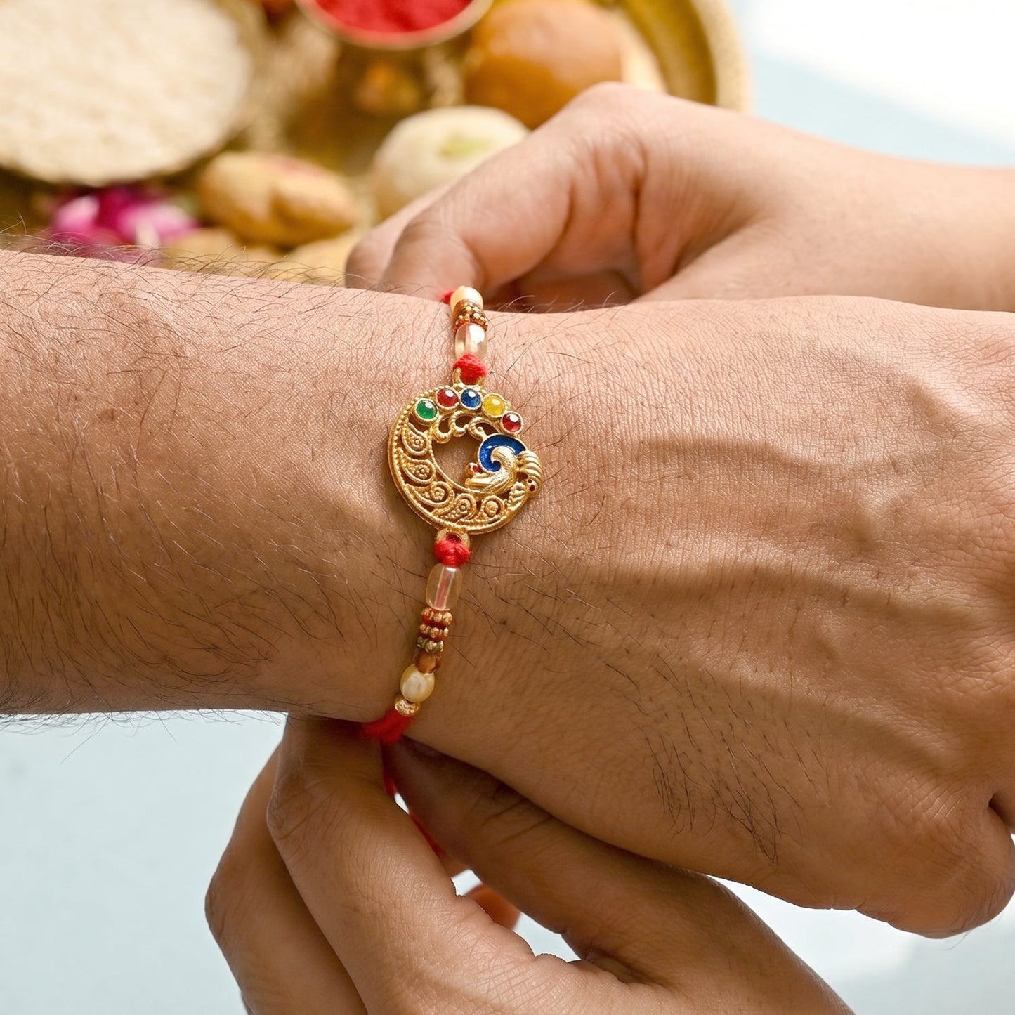 Antique Coin Bhabhi Rakhi laid flat, highlighting the coin and thread design