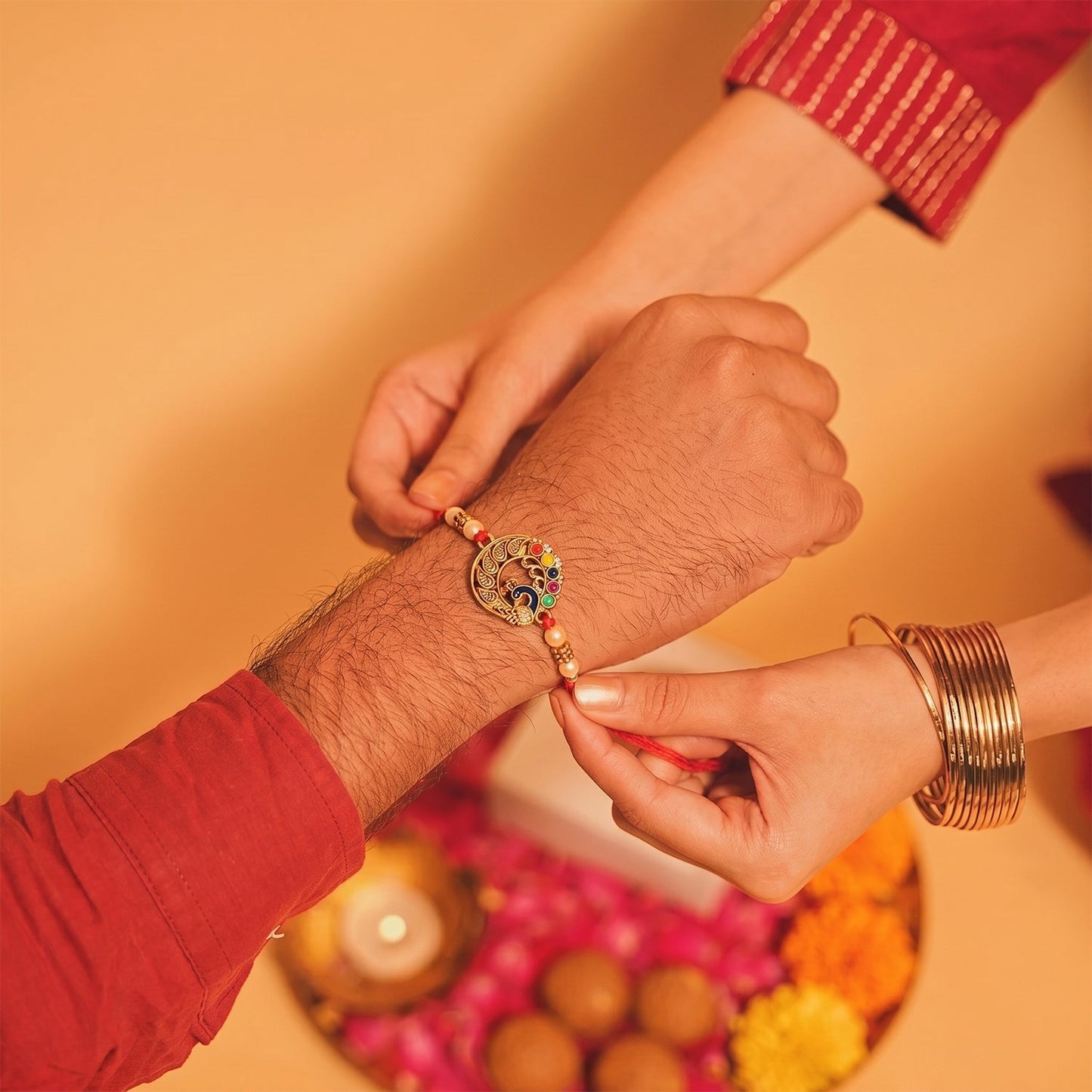 Colourful thread and pearl decorated Peacock Motif Bhabhi Rakhi.