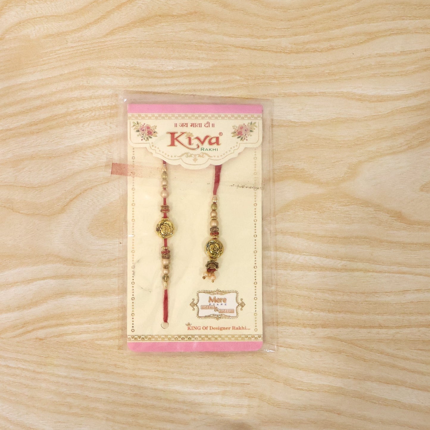 Antique Bhabhi Rakhi with pearl drop displayed on white background