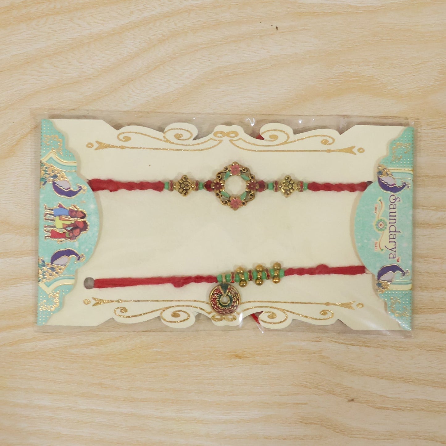 Traditional Bhabhi Rakhi with floral stones and pearl accents displayed with gifts
