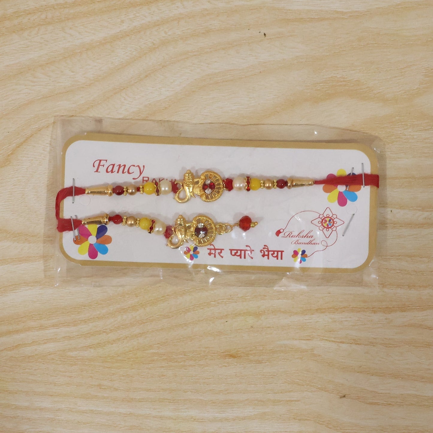 Complete view of golden Ganesha Bhabhi rakhi with pearl beads