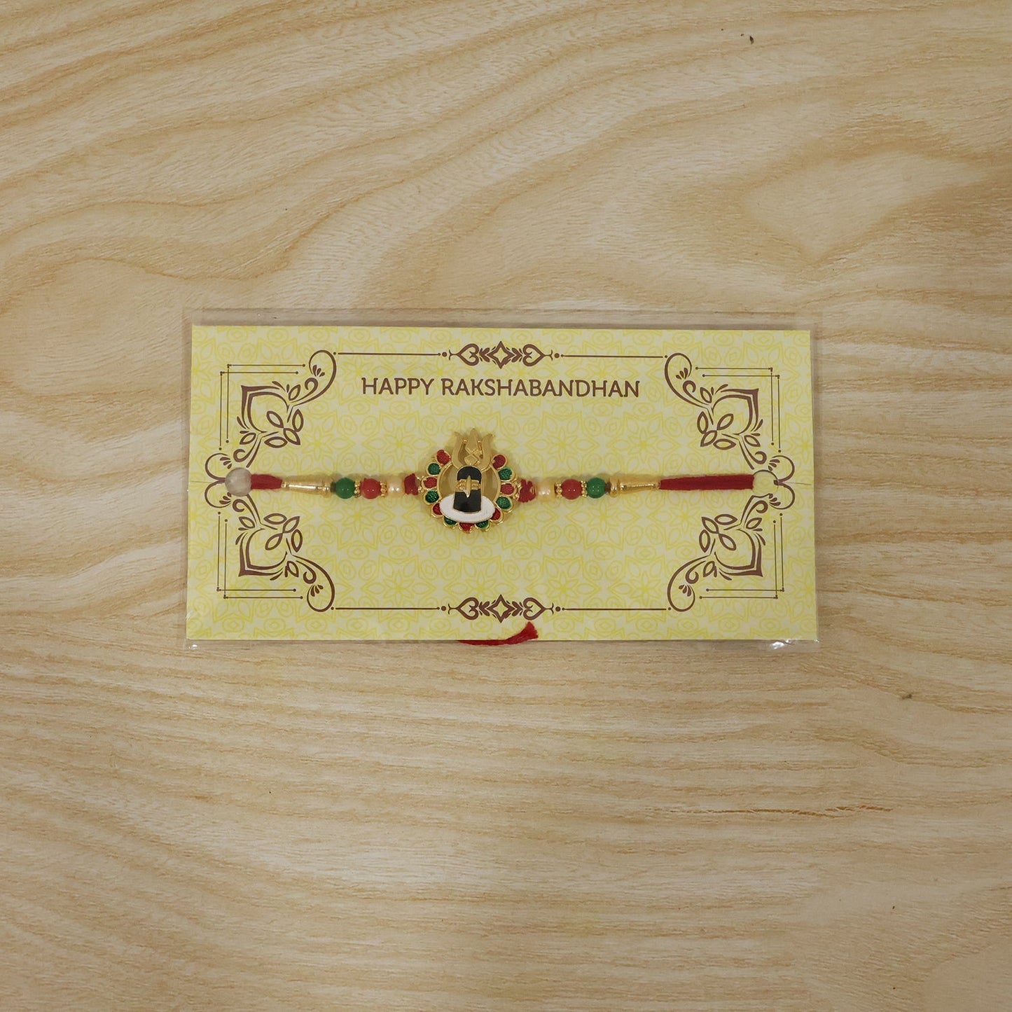 Shivling Design Rakhi displayed on a decorative surface